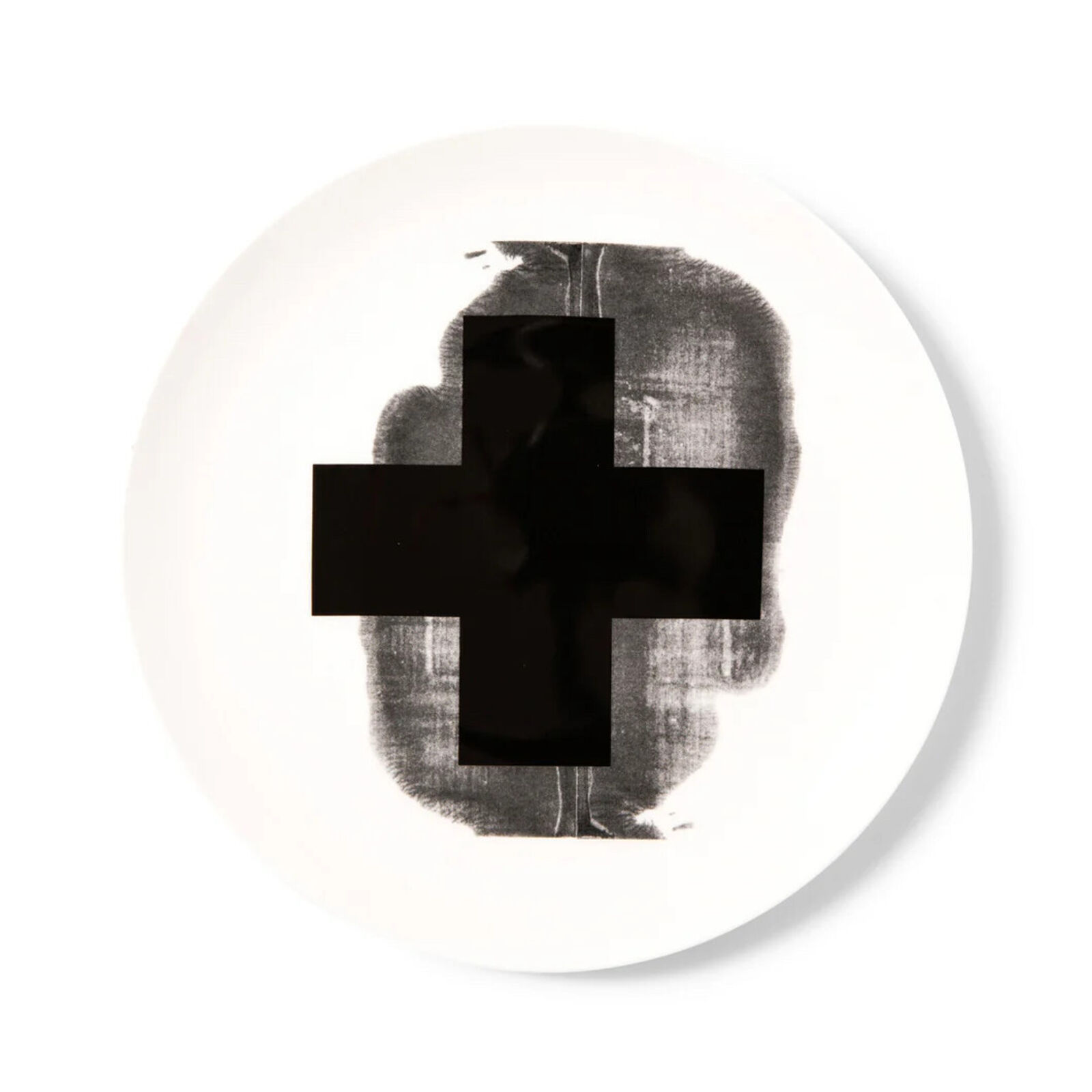 A white plate with a black cross on it.