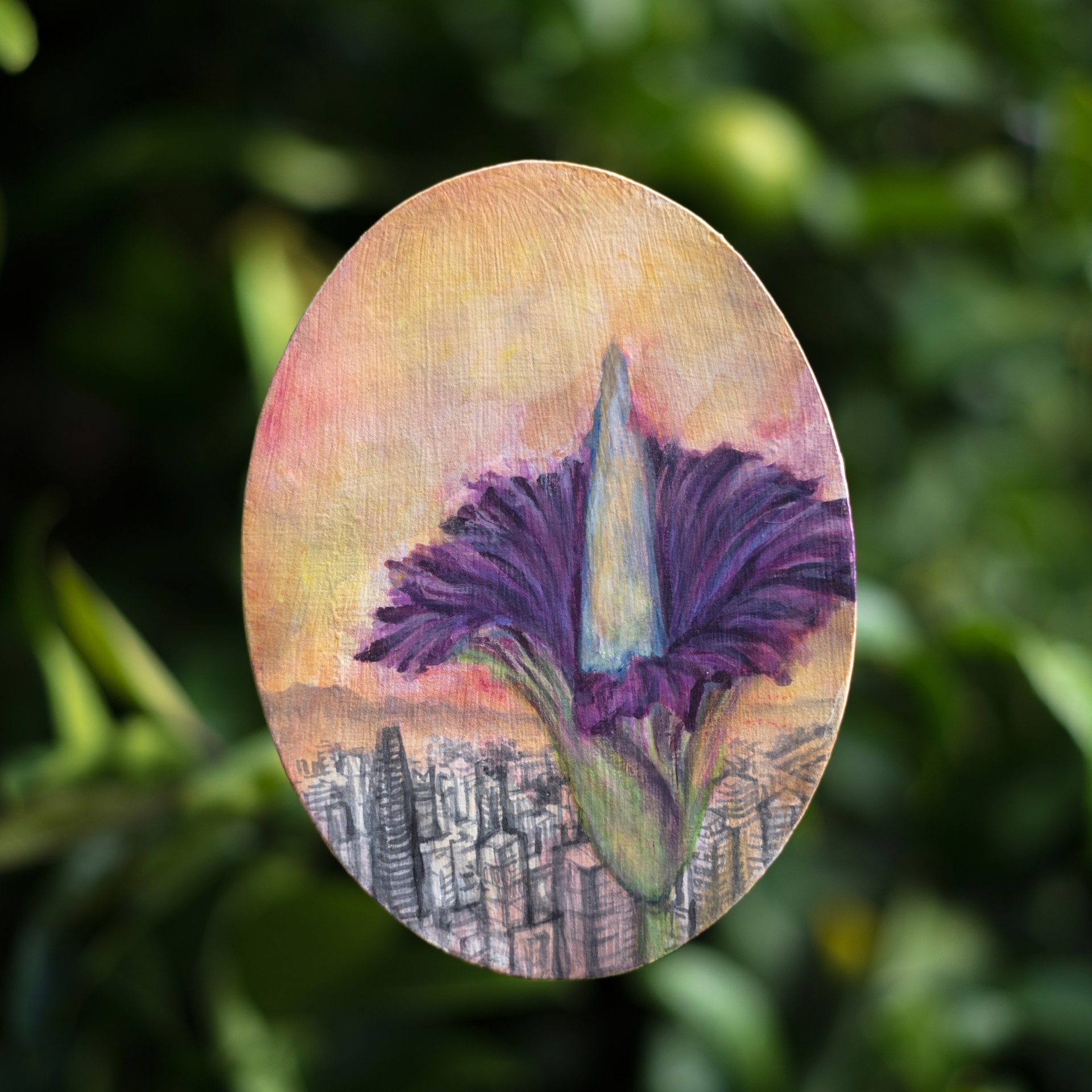 A painting of a purple flower on a wooden oval.