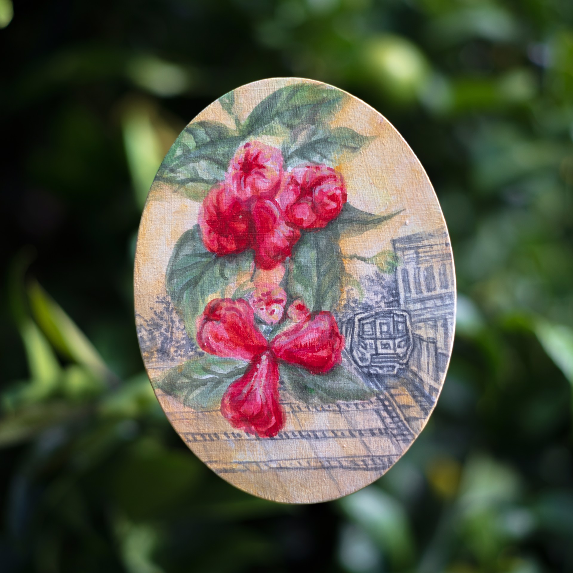 A painting of red flowers on a wooden plaque.