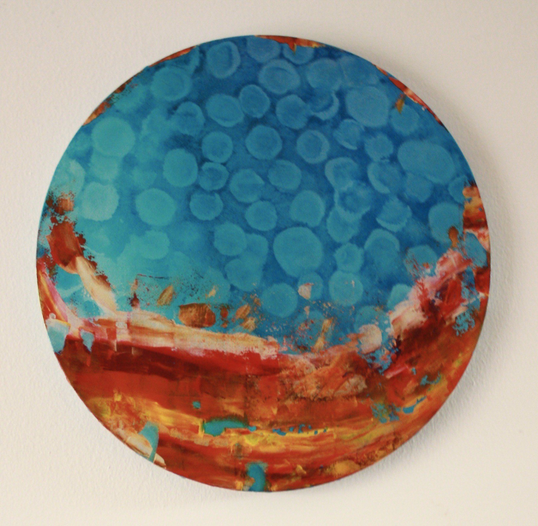 A painting on a wall with a blue and red background.