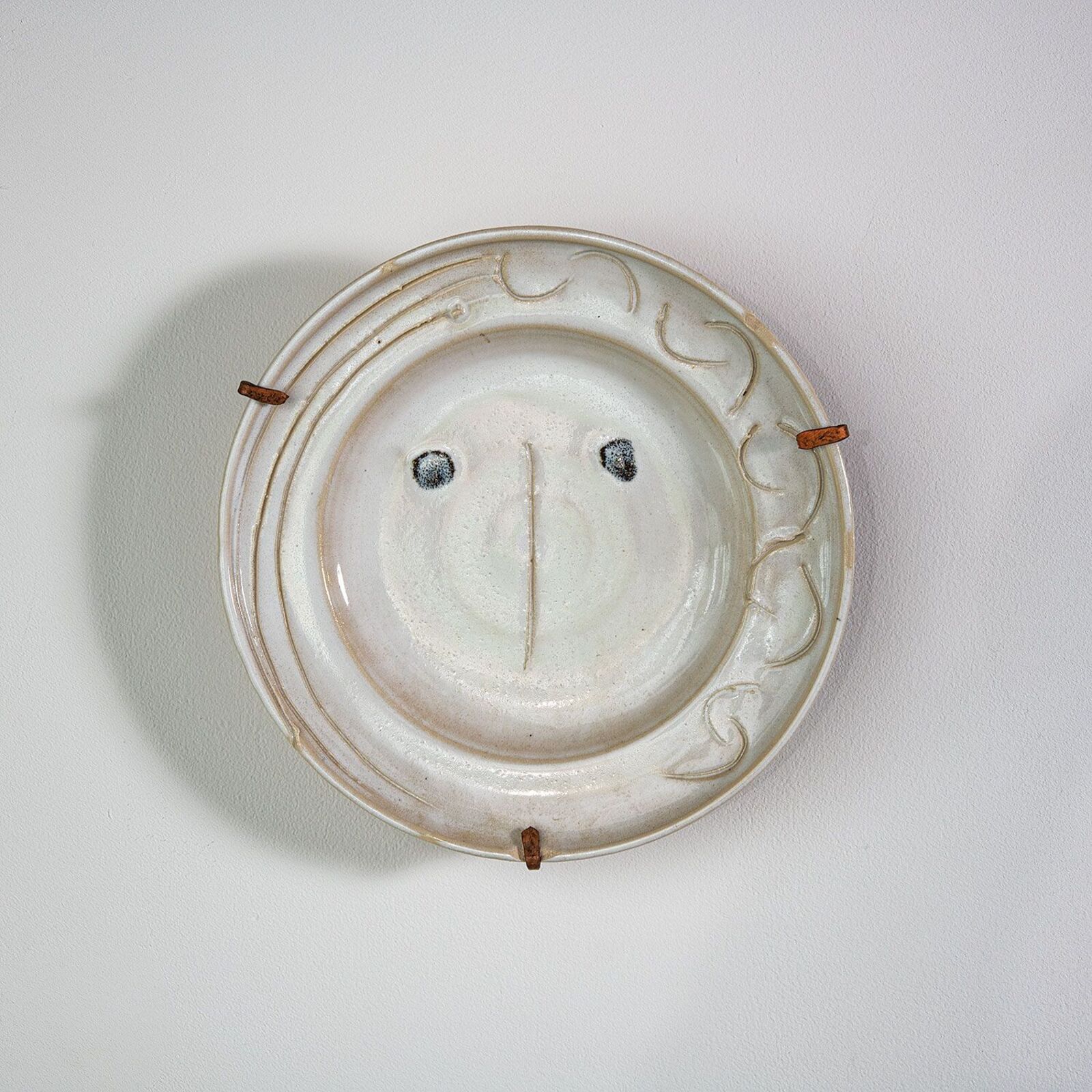 A white plate with a smiley face on it.