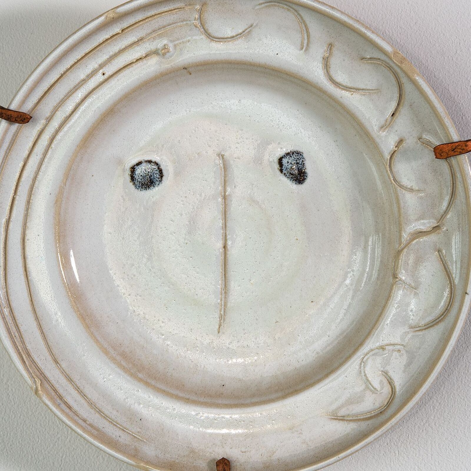 A white plate with a smiley face on it.