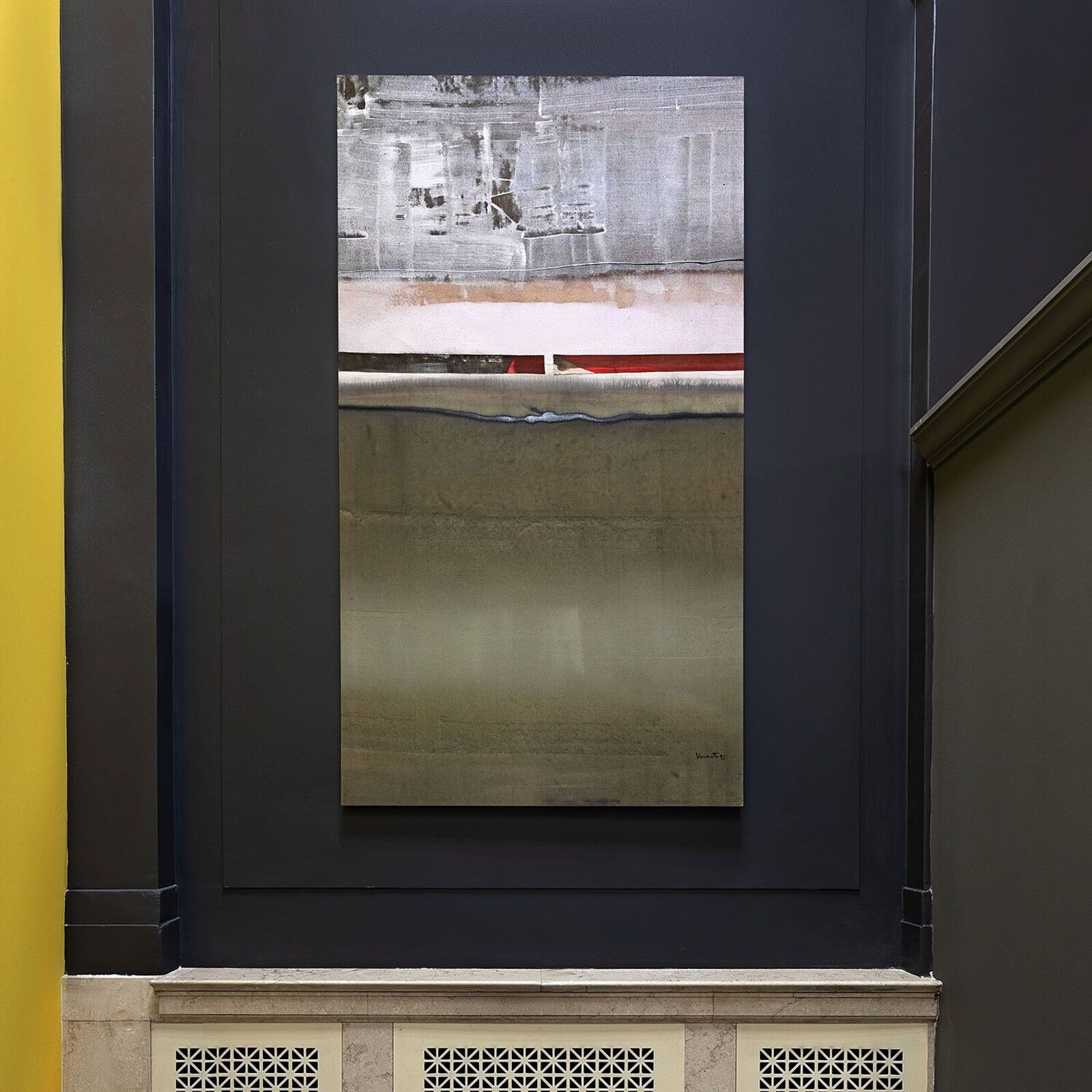 A vertical rectangular artwork featuring layered textures and muted tones within a dark frame.