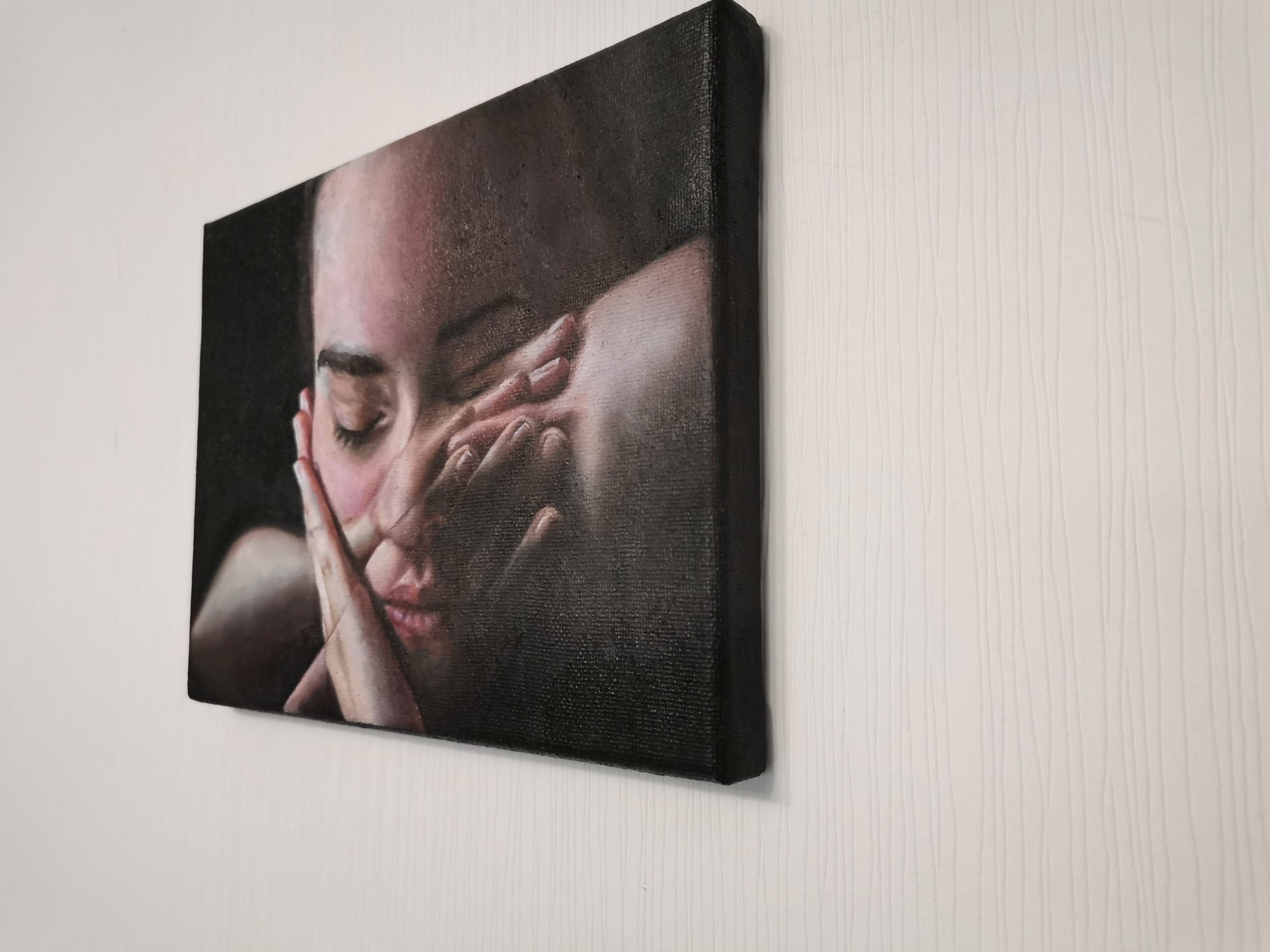 A painting of a woman covering her face with her hands.