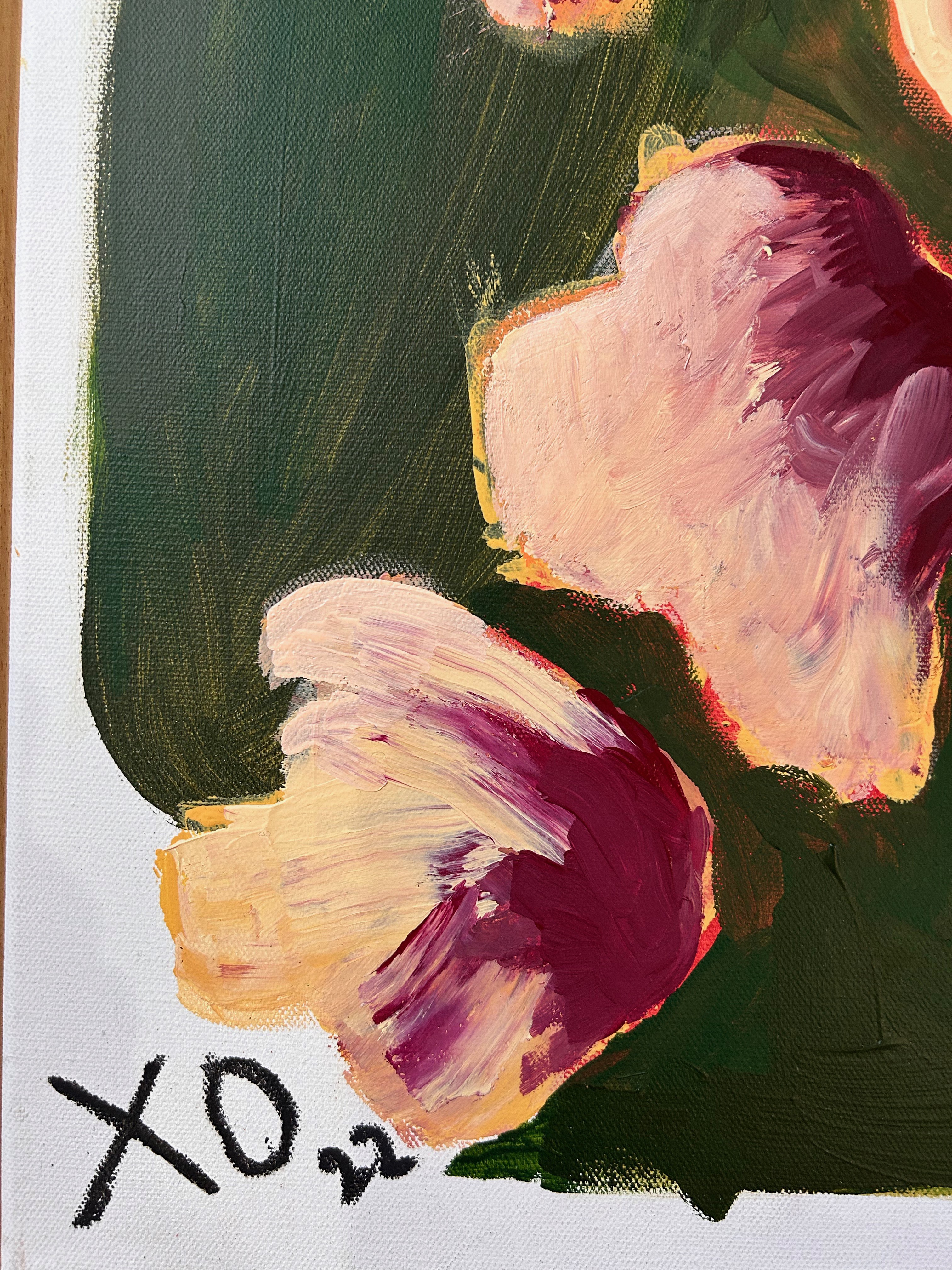 A painting of flowers in a wooden frame on a wall.