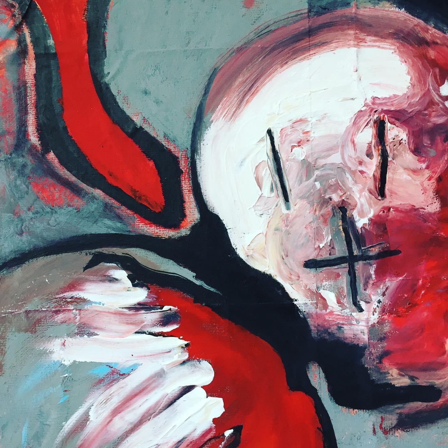 A painting of a woman's face with a yellow cross on it.