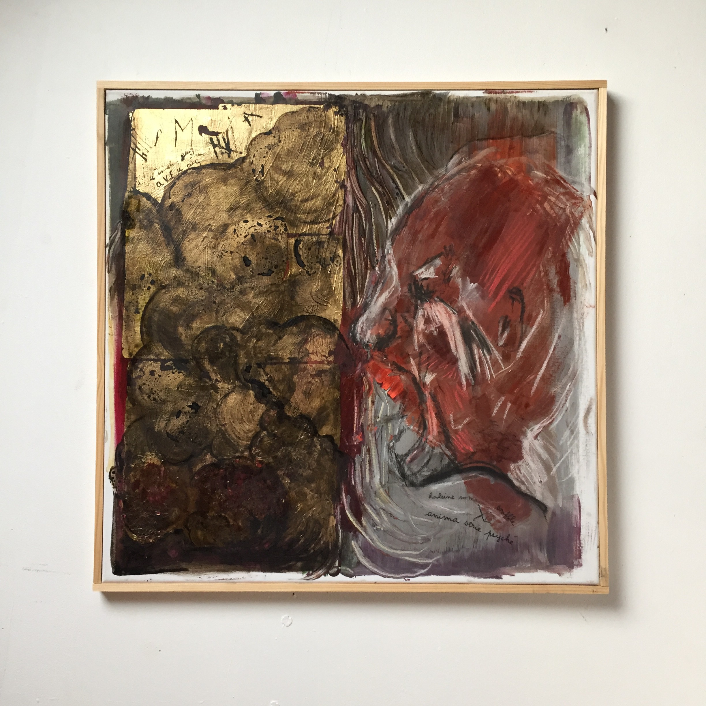 A painting of a woman's face with red and gold paint.