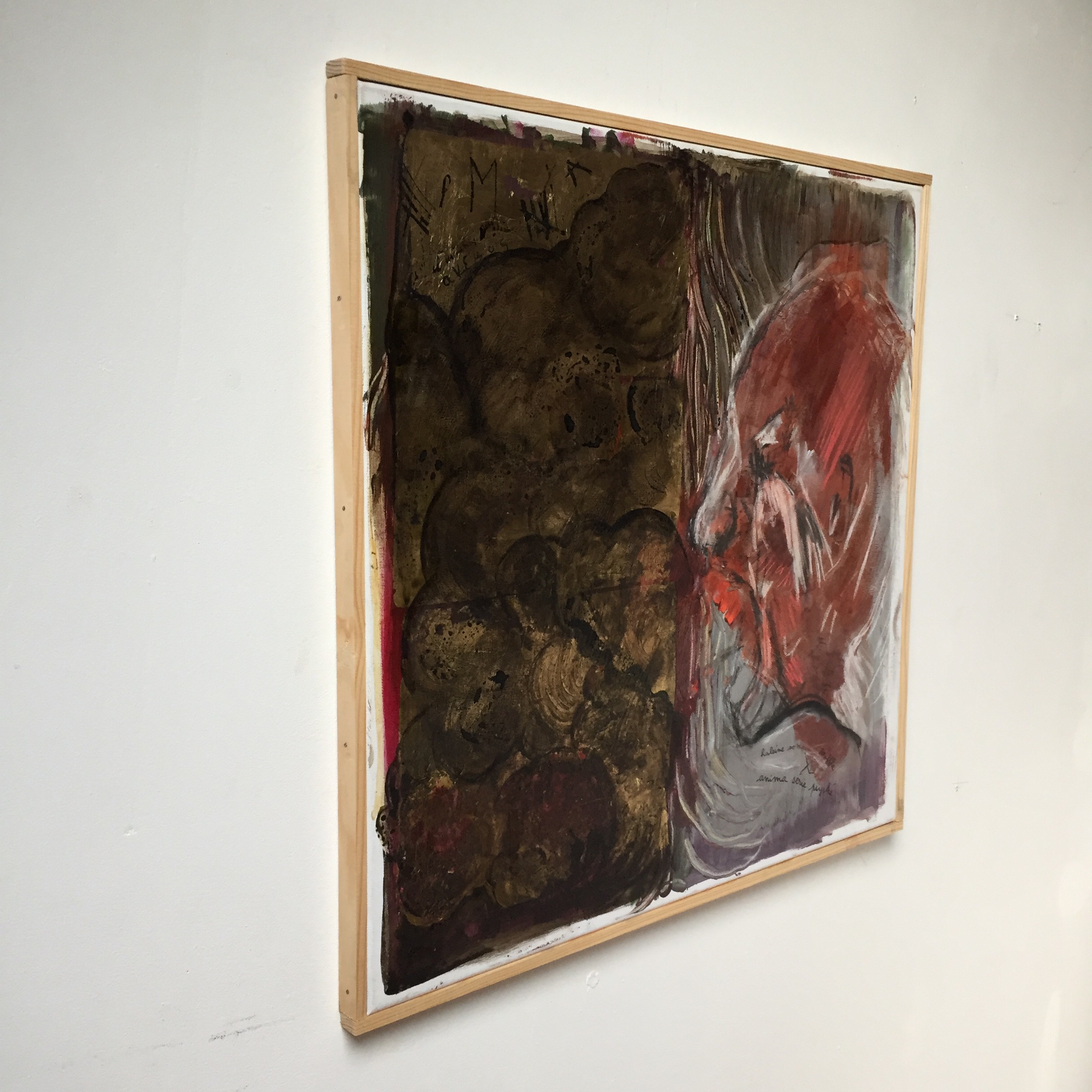 A painting of a woman's face with red and gold paint.