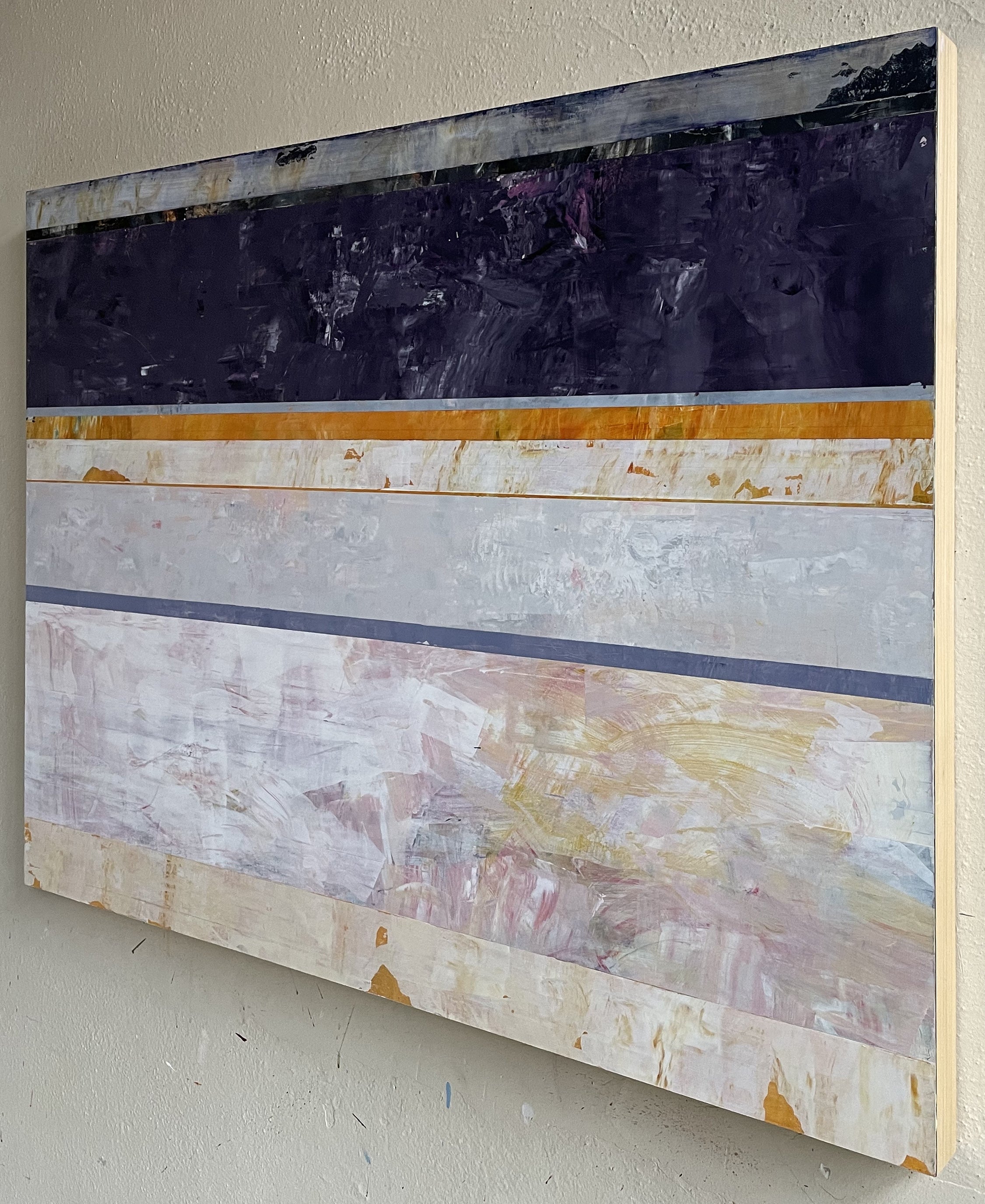 A painting on a white wall with a purple and yellow stripe.