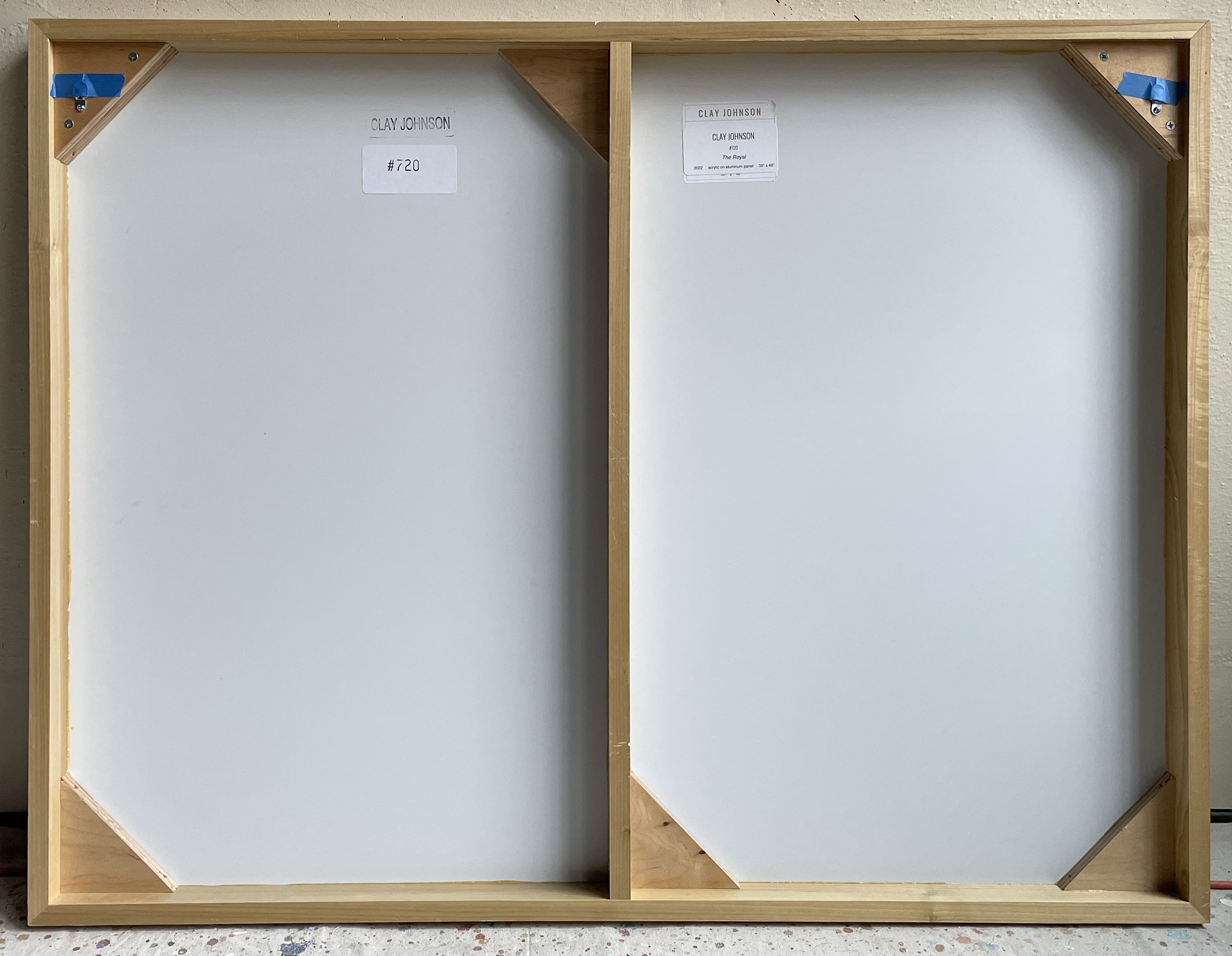 A painting on a white wall with a purple and yellow stripe.