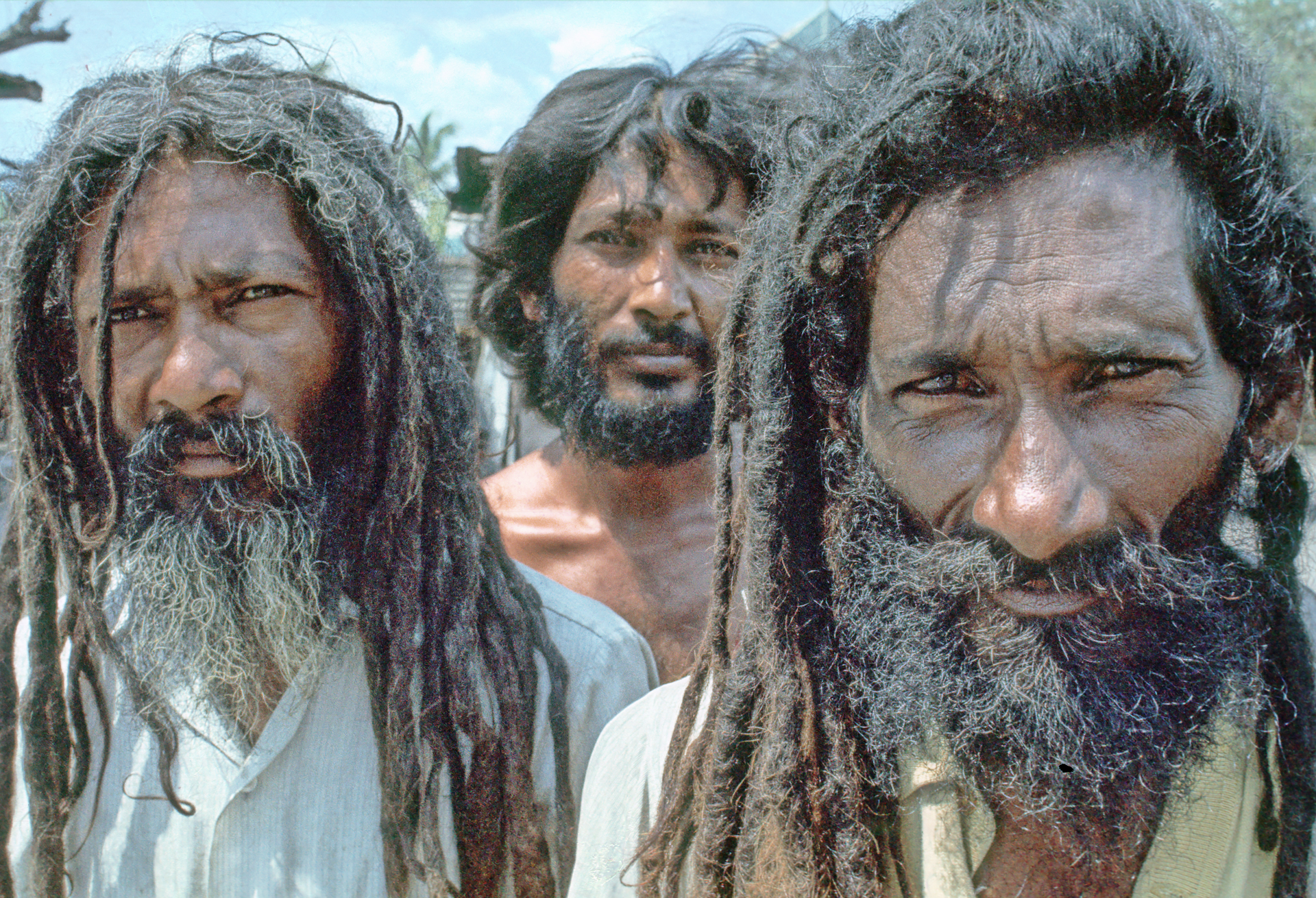 A group of three men with long hair and beards.