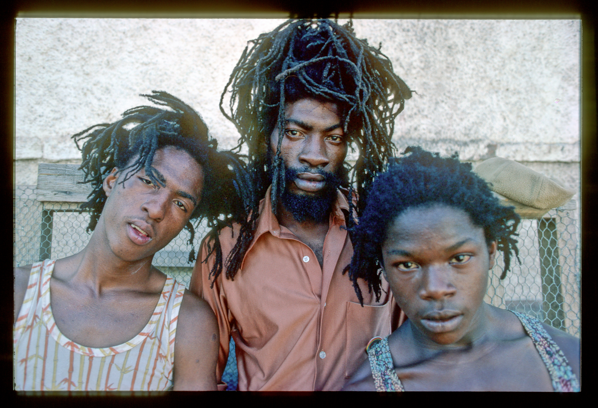 A group of three men with dreadlocks standing next to each other.