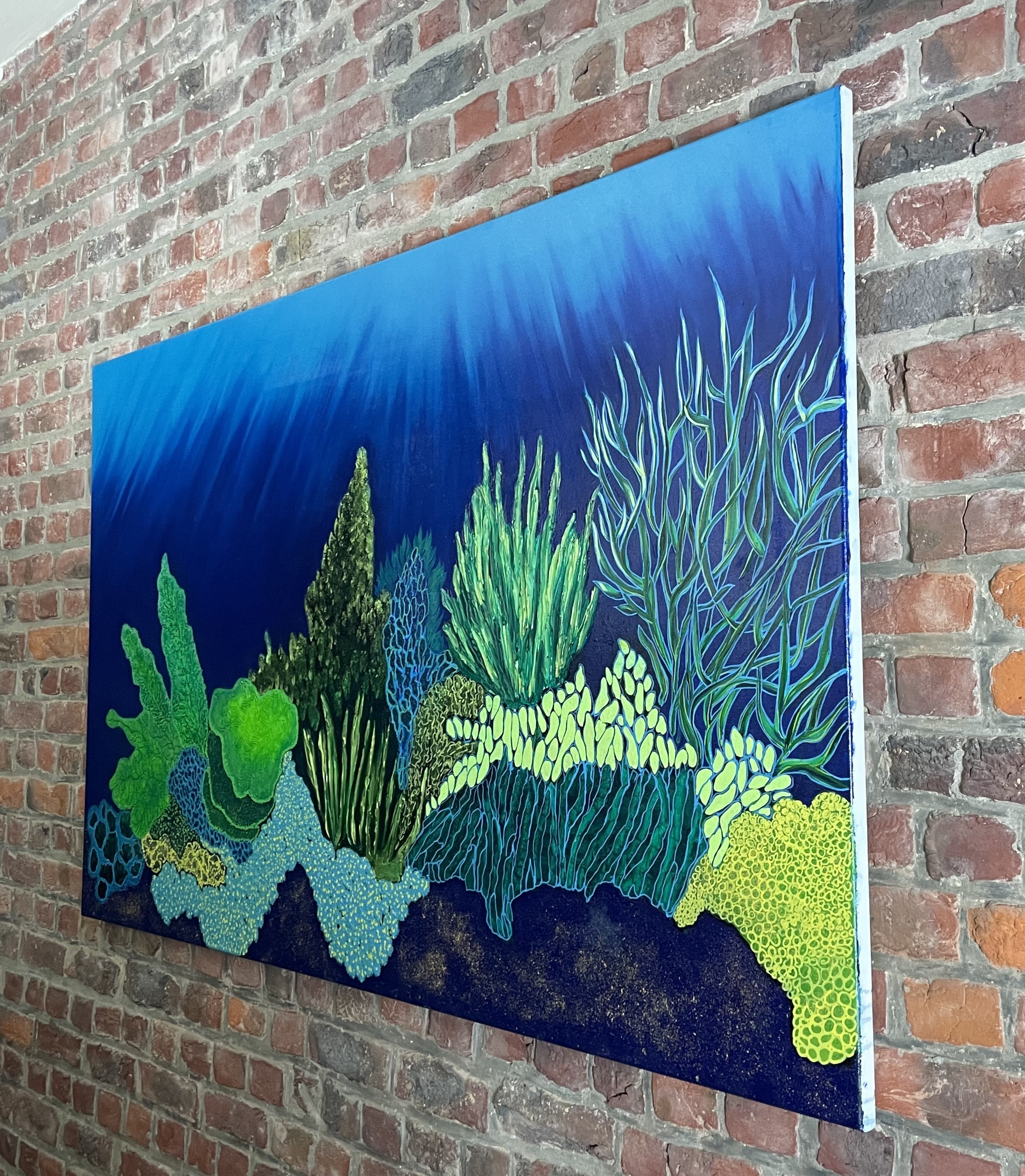 A painting on a brick wall in a room.