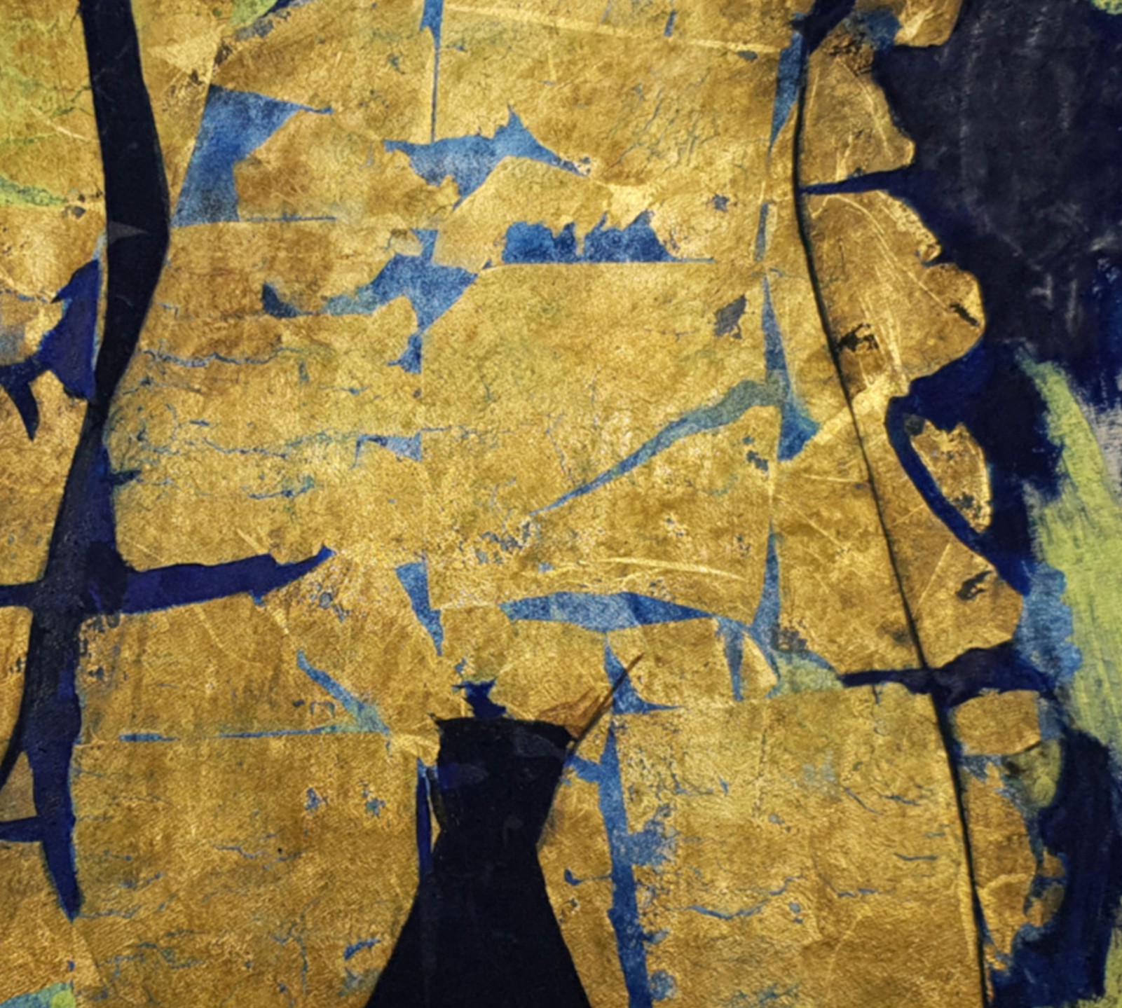 A close up of a piece of paper with gold and blue paint on it.