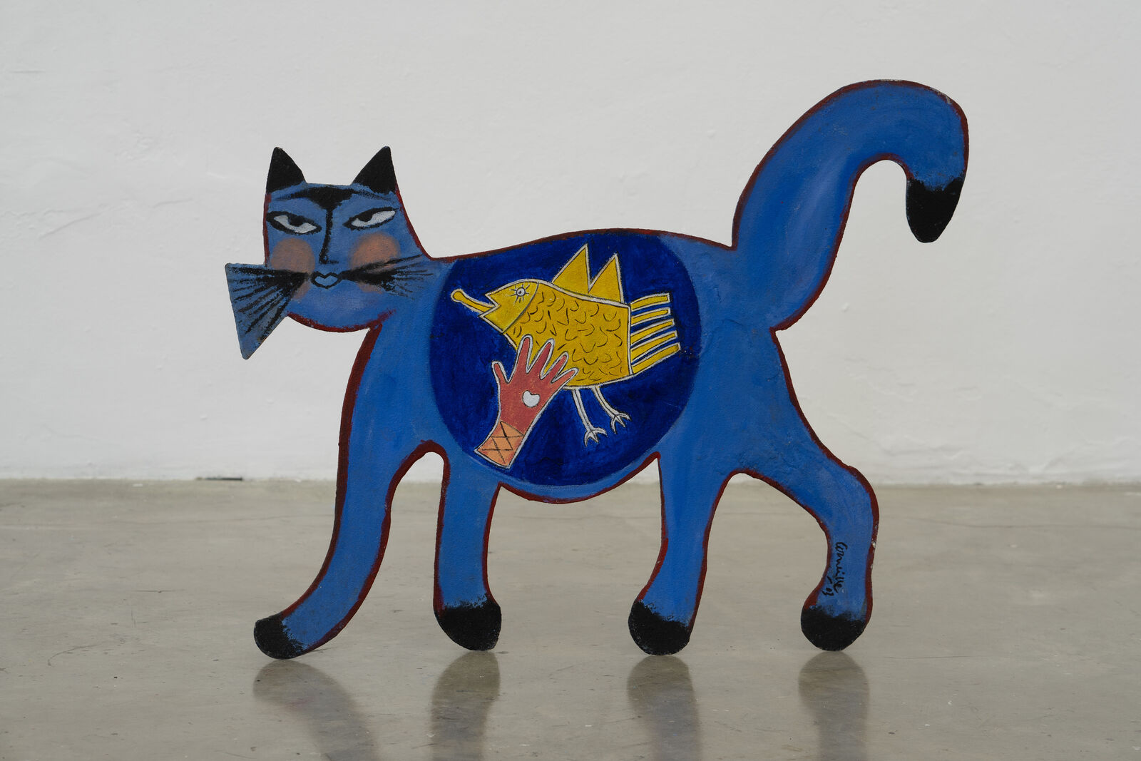 A blue cat with a fish in its mouth.