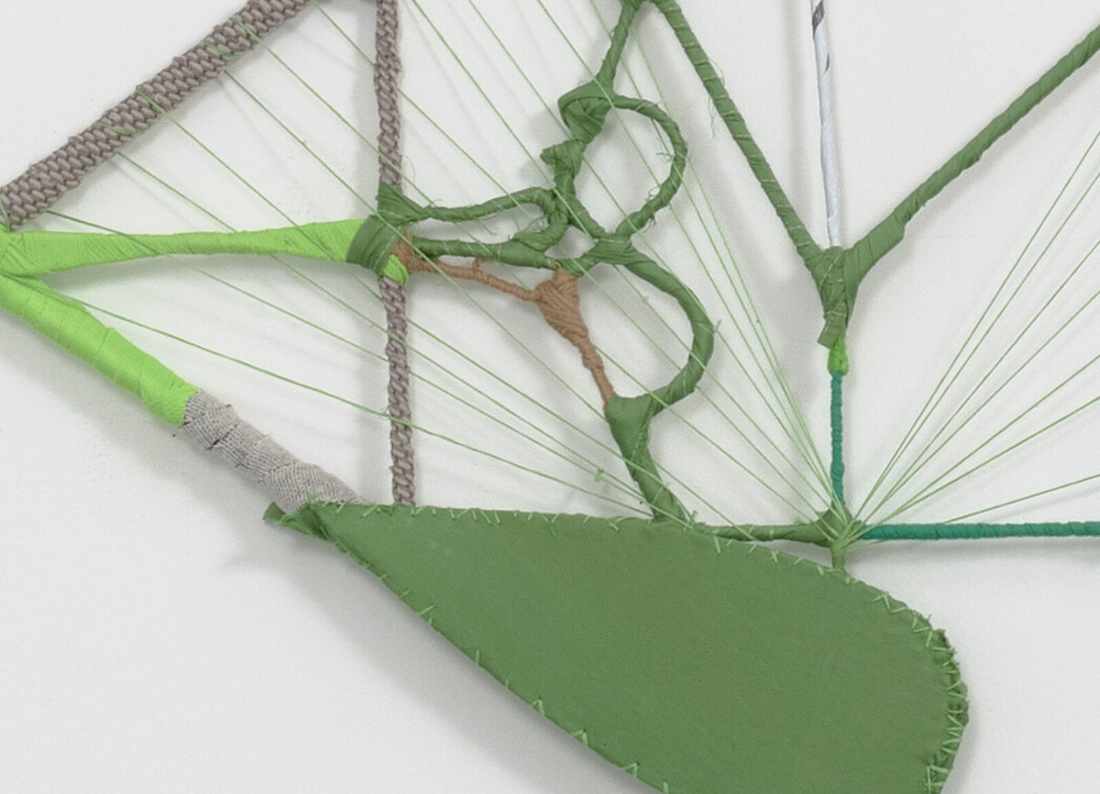 A wireframe sculpture of a biplane constructed from wrapped rods and string.