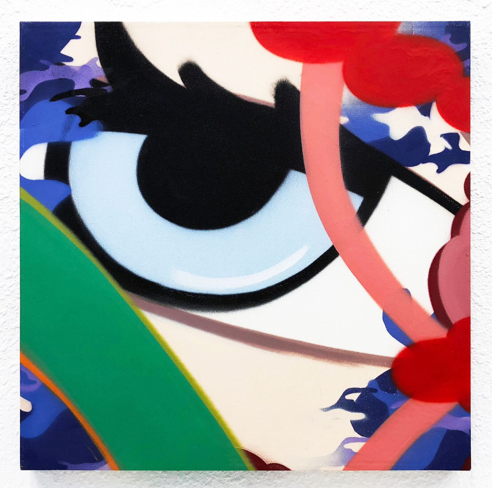 A painting of an eye on a white wall.