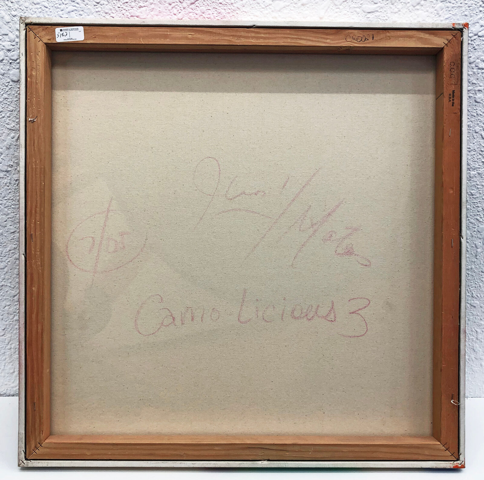 A painting of an eye on a white wall.