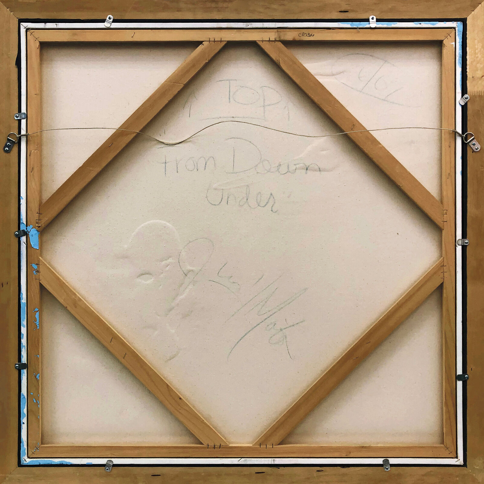 A painting of a woman's face on a wall.