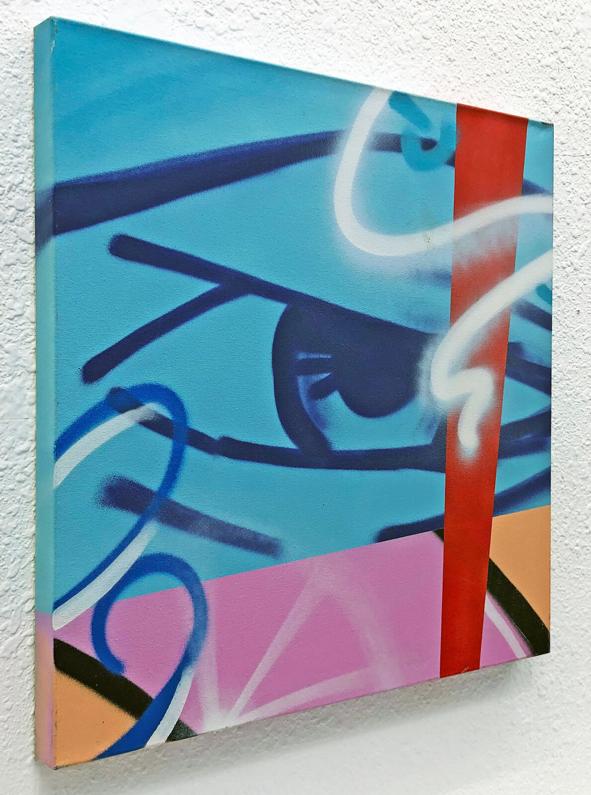 A painting on a wall with graffiti on it. 