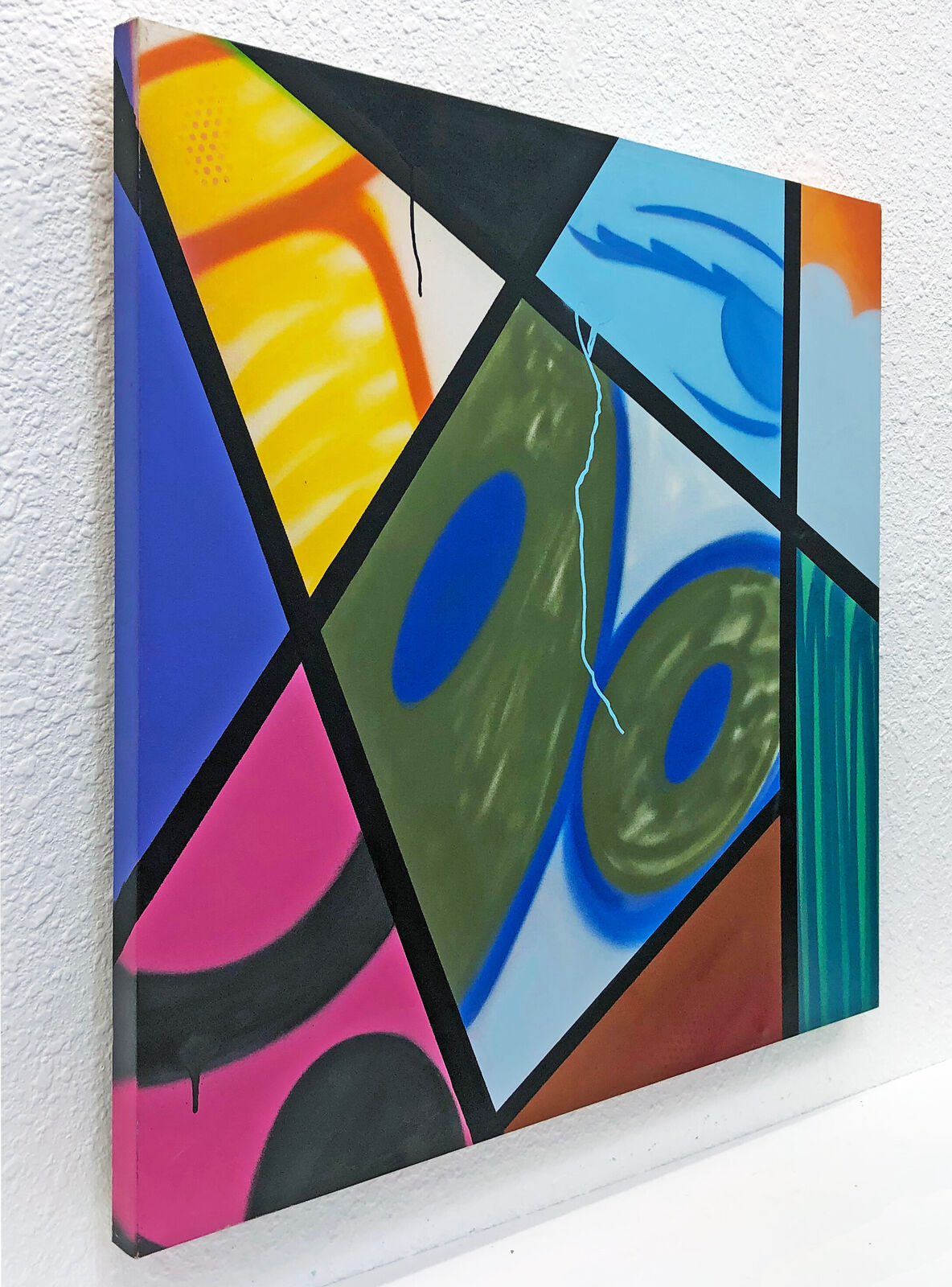 A painting on a white wall with a string attached to it.