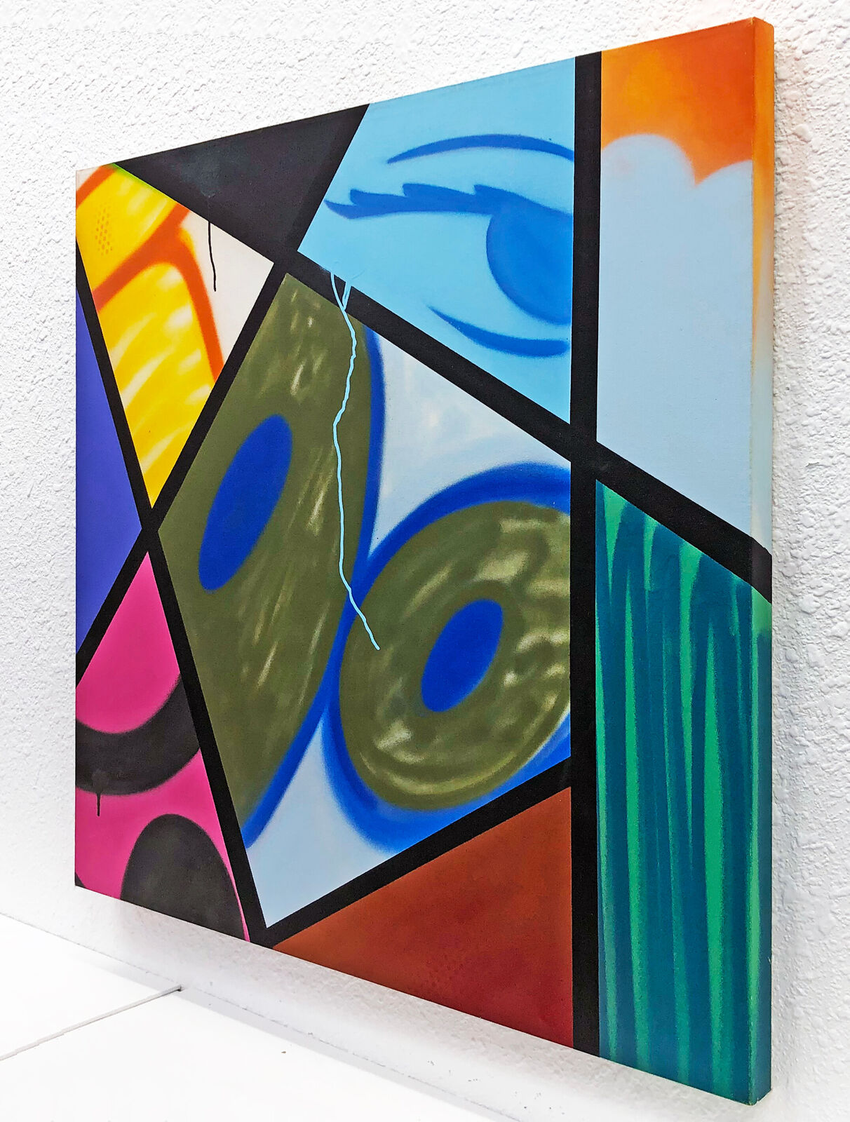 A painting on a white wall with a string attached to it.