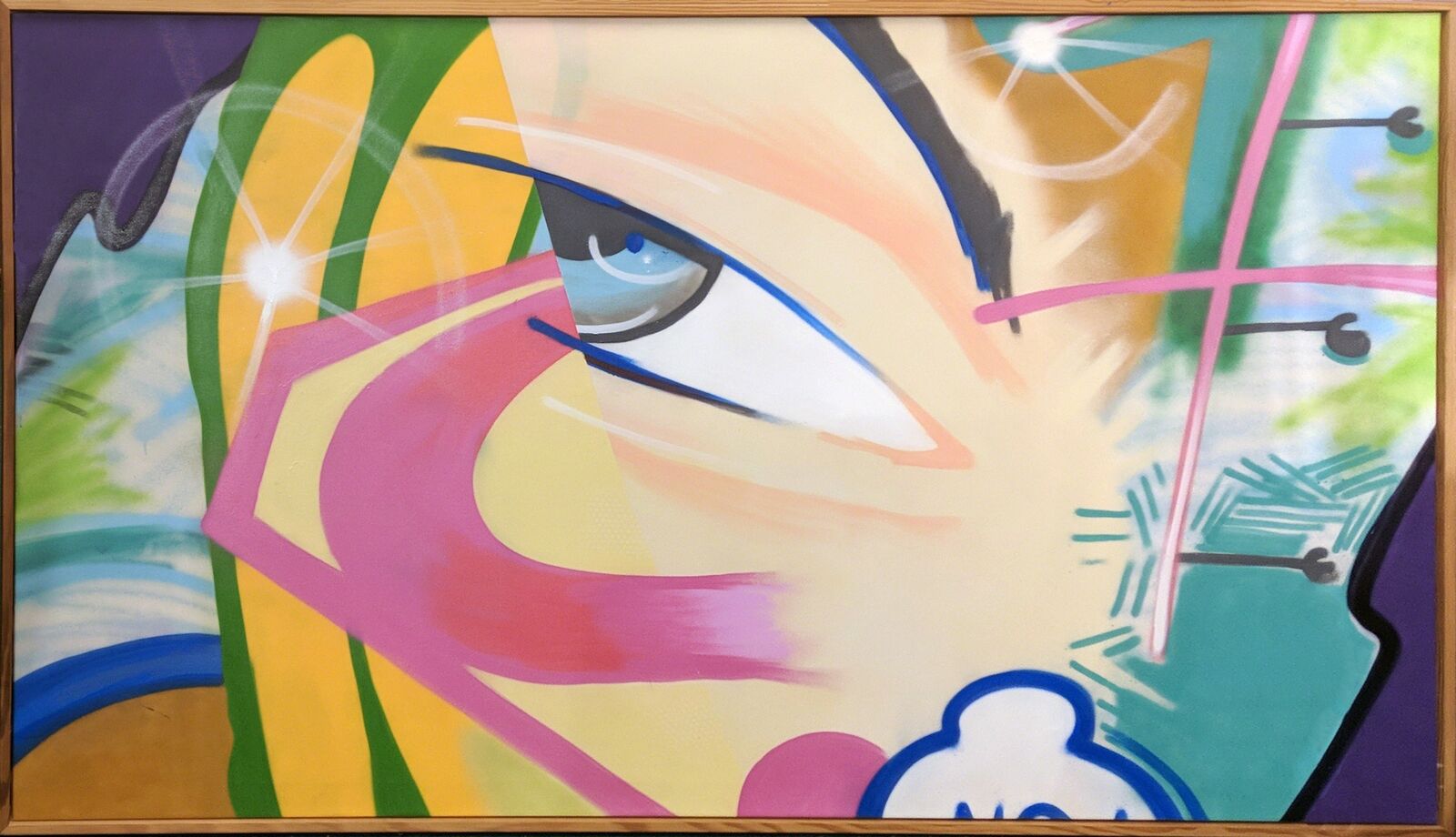 A painting of a woman's face on a wall.