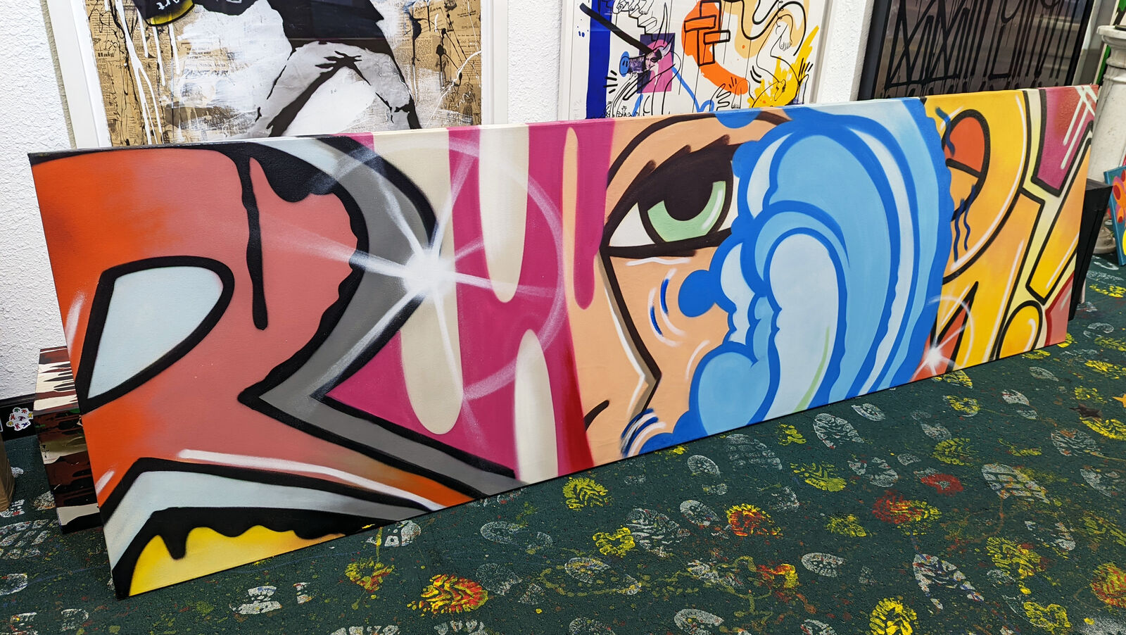 a close up of a painting of a woman's face on a wall