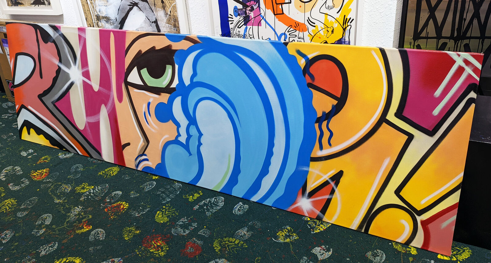 a close up of a painting of a woman's face on a wall