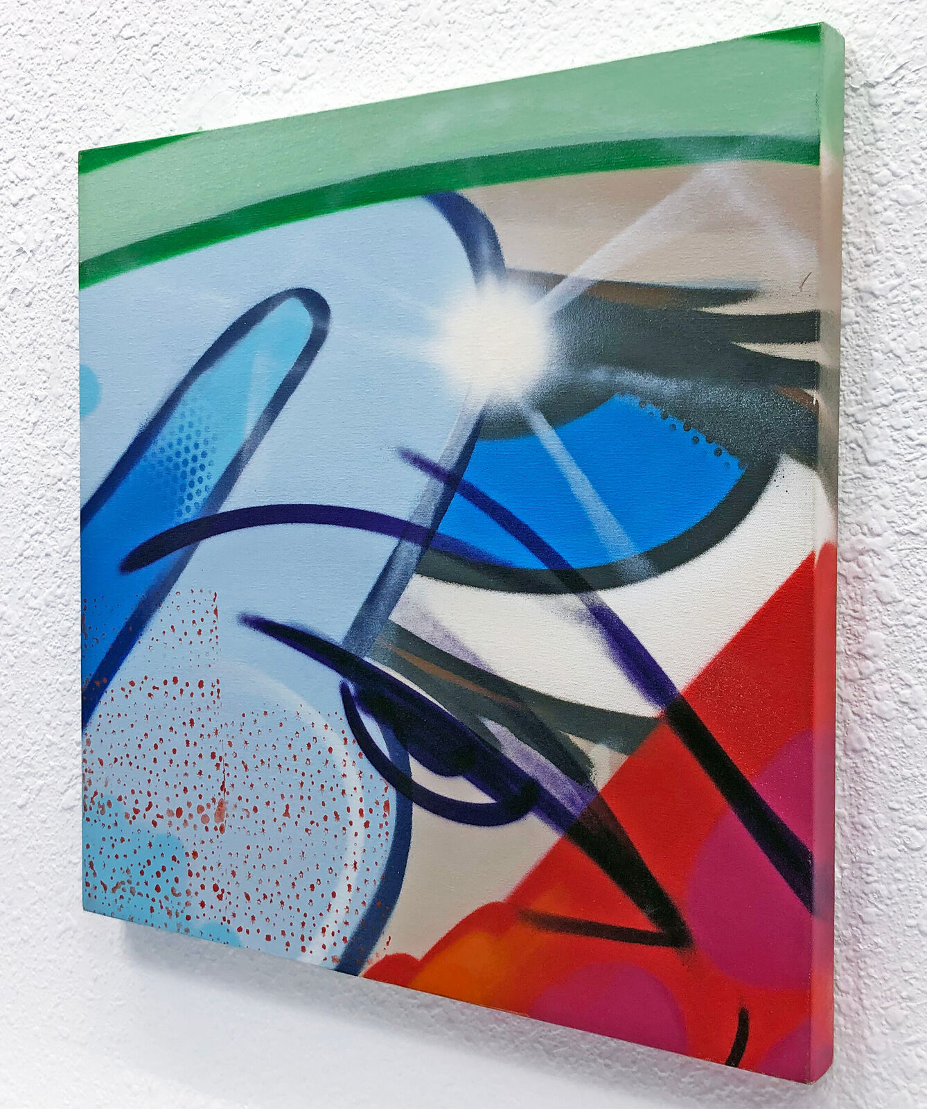 A painting on a white wall with a bright light shining through it.