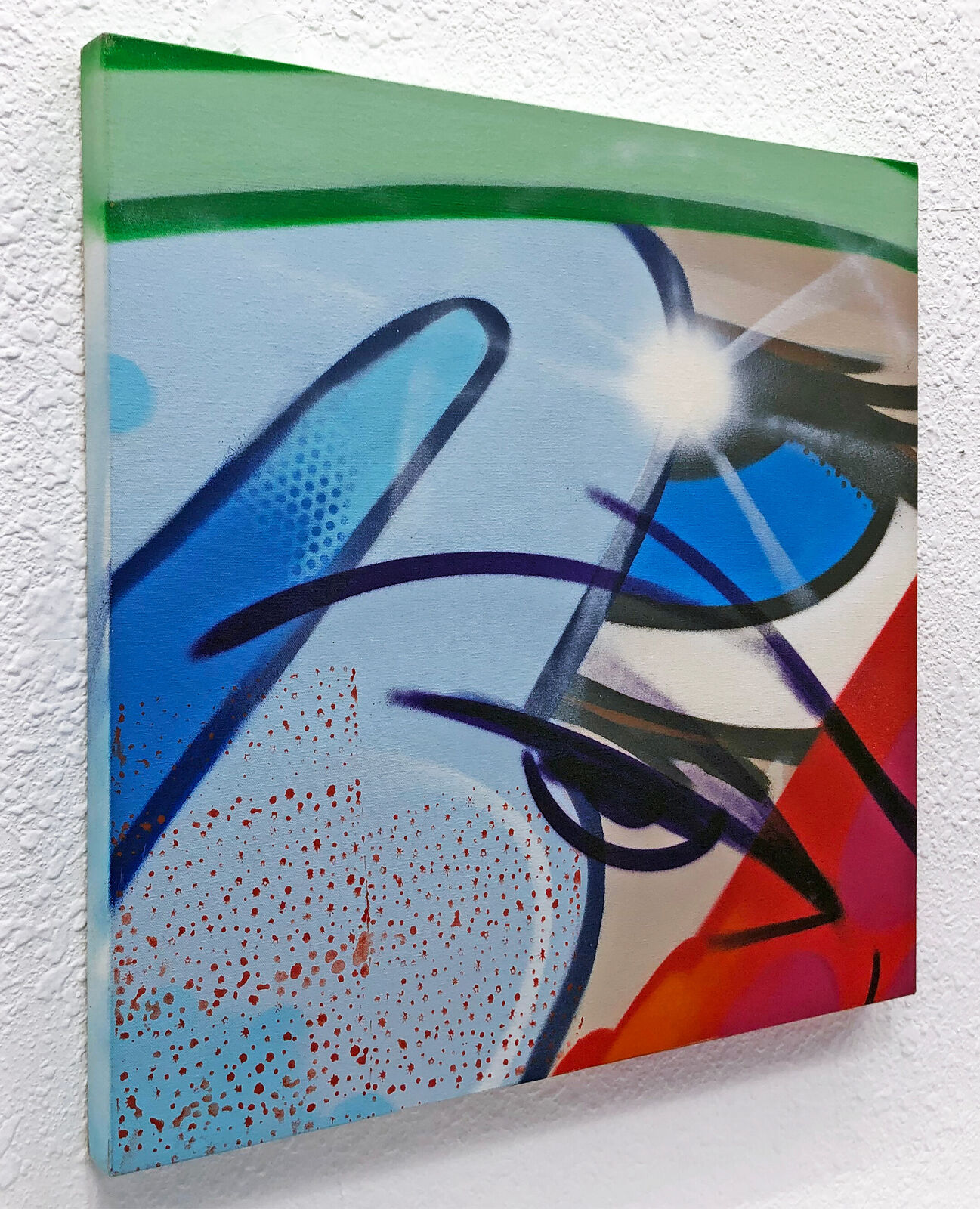 A painting on a white wall with a bright light shining through it.