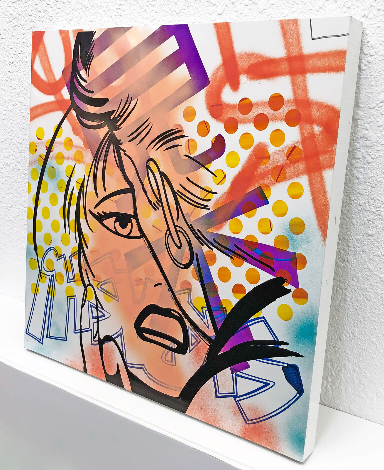 A painting of a woman's face on a wall.