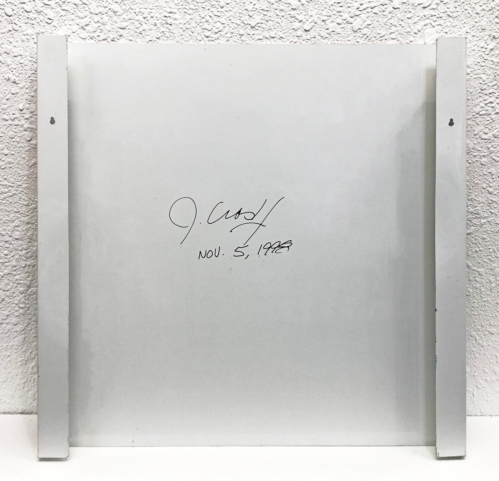 A painting of a woman's face on a wall.