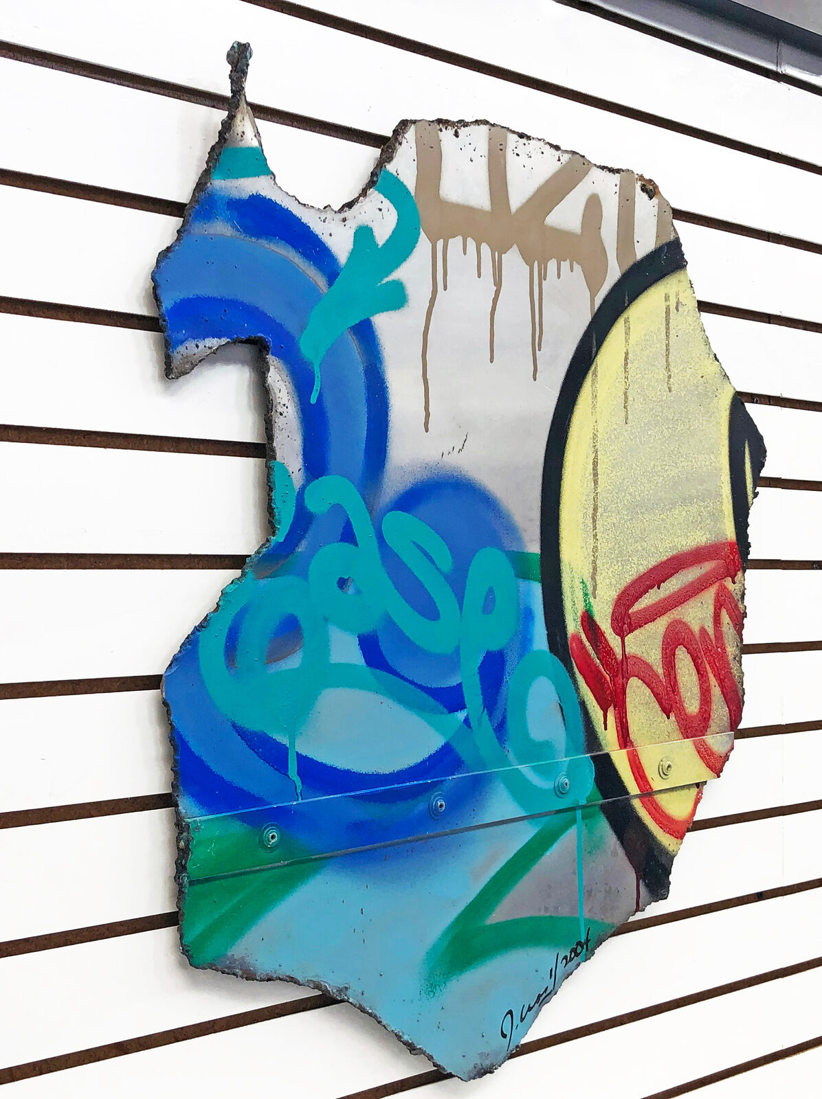 A piece of metal with graffiti on it. 