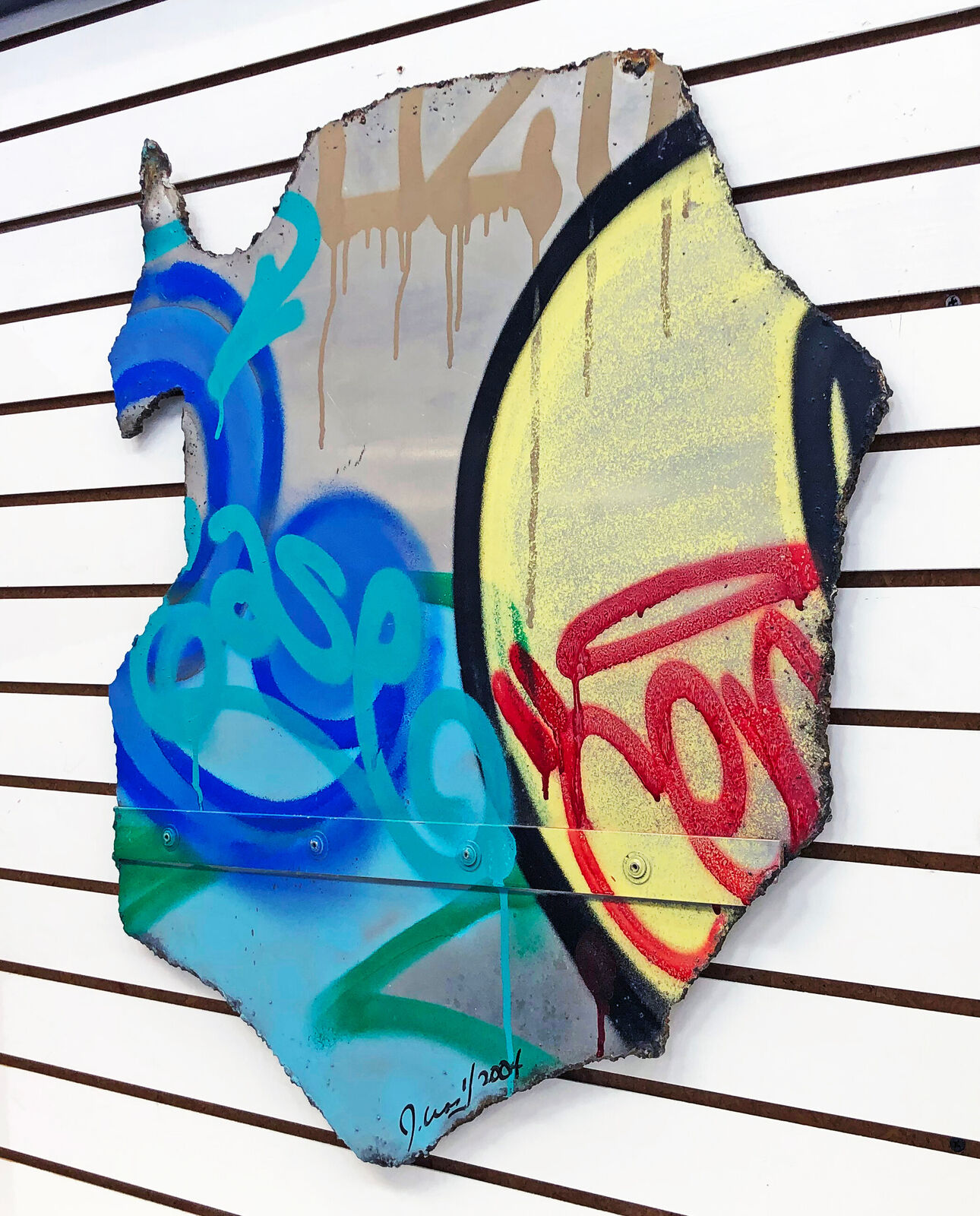 A piece of metal with graffiti on it. 