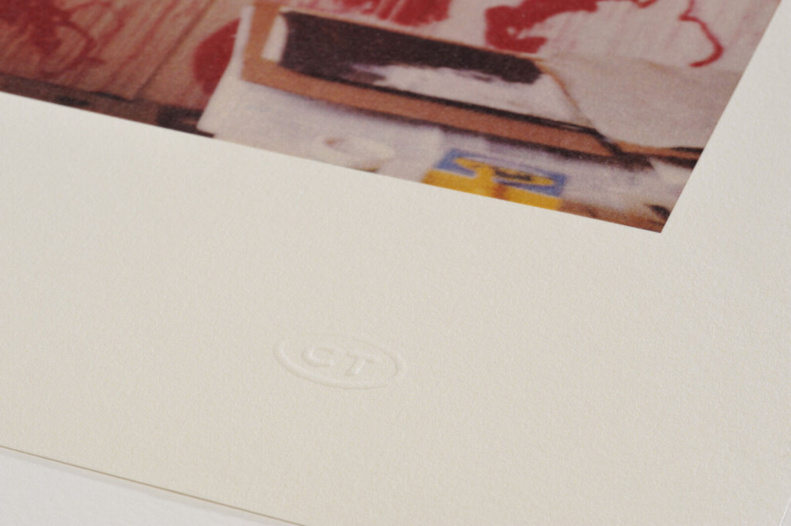 A picture of a white frame on a wall in a room.