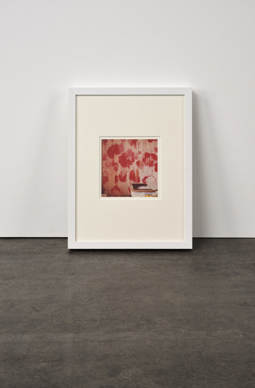 A picture of a white frame on a wall in a room.