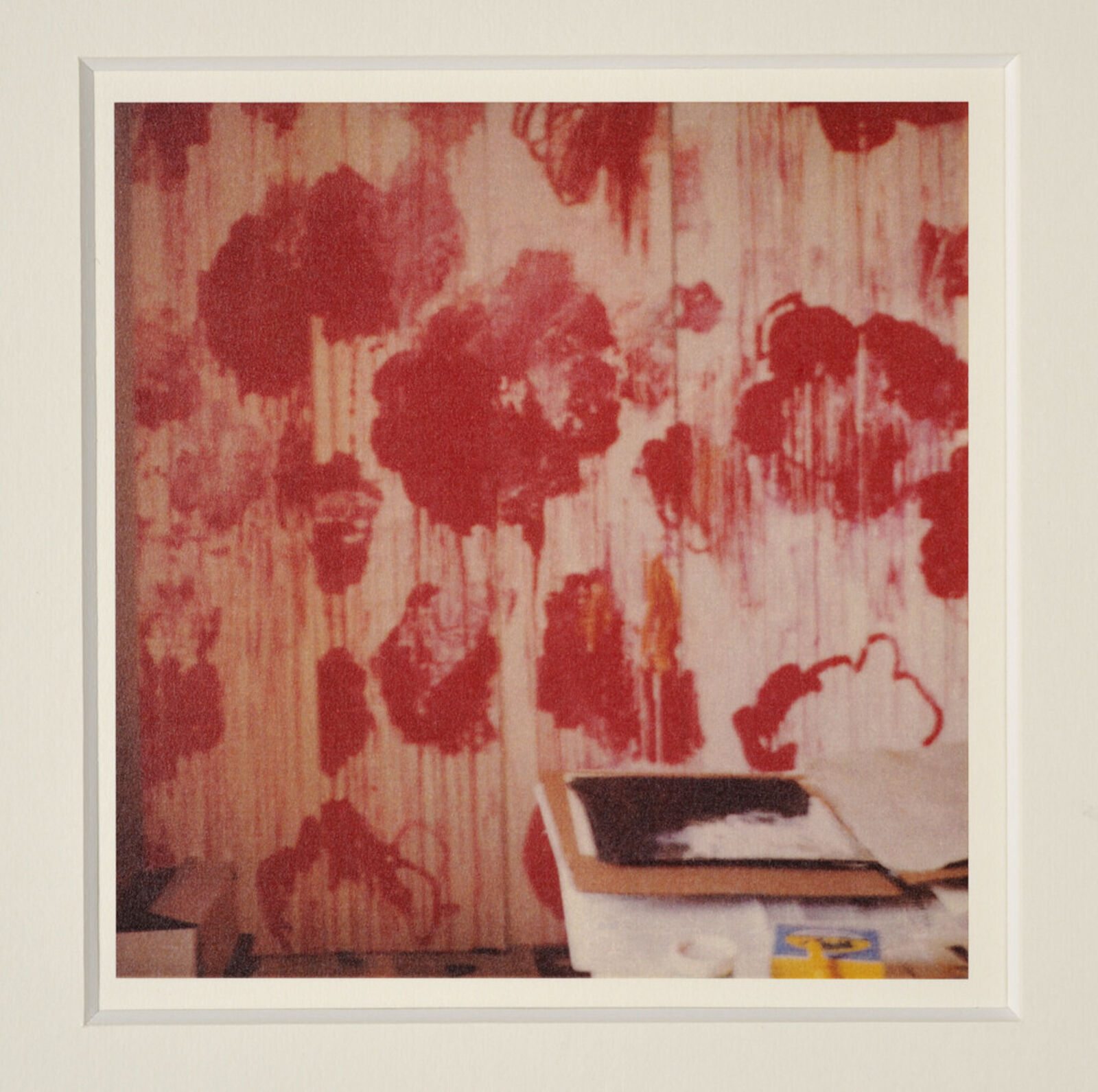 A picture of a white frame on a wall in a room.