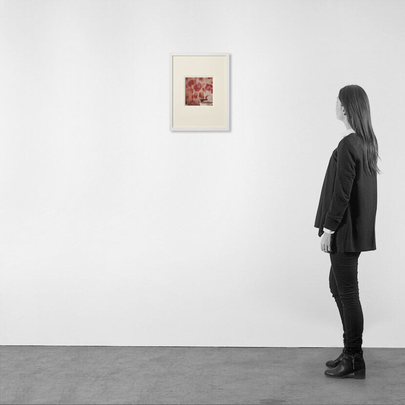 A picture of a white frame on a wall in a room.