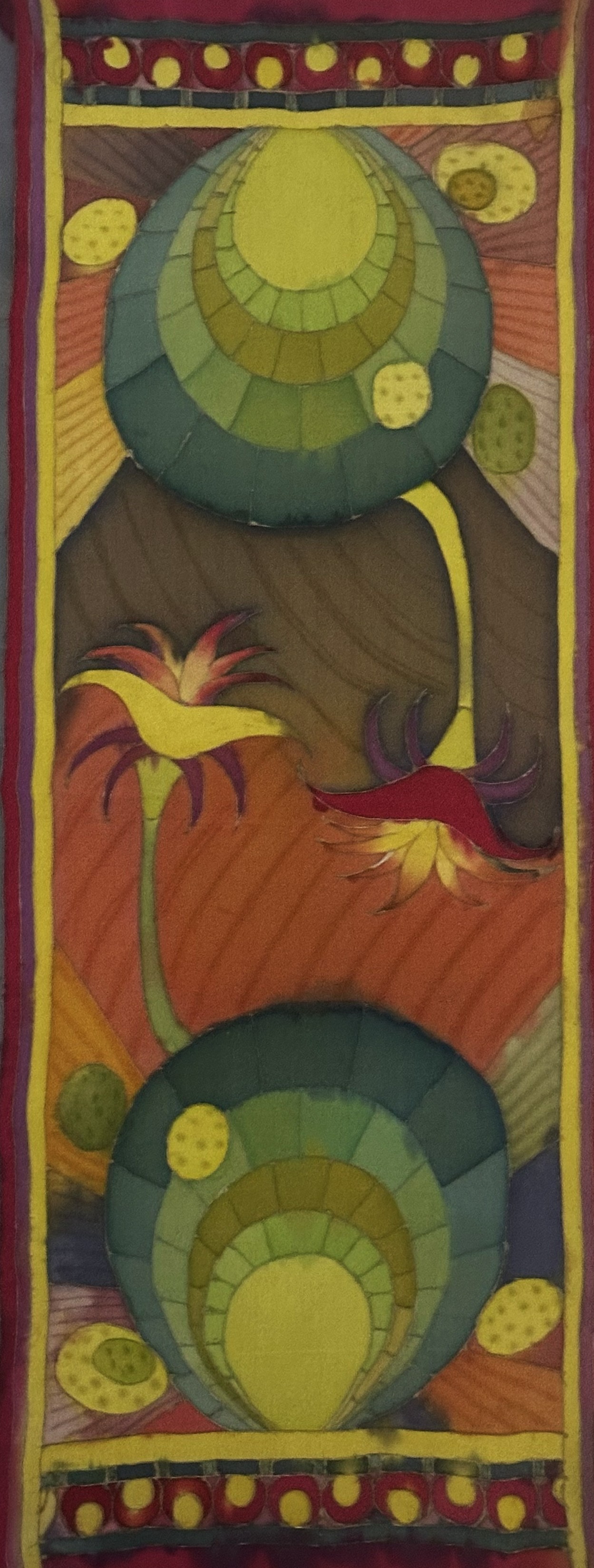A painting of a colorful wall hanging on a wall.