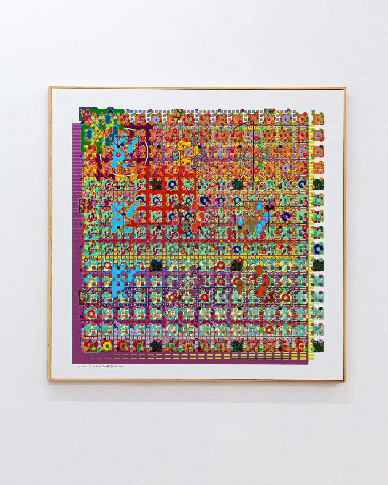 A colorful, dense grid of geometric shapes and symbols in a framed print.