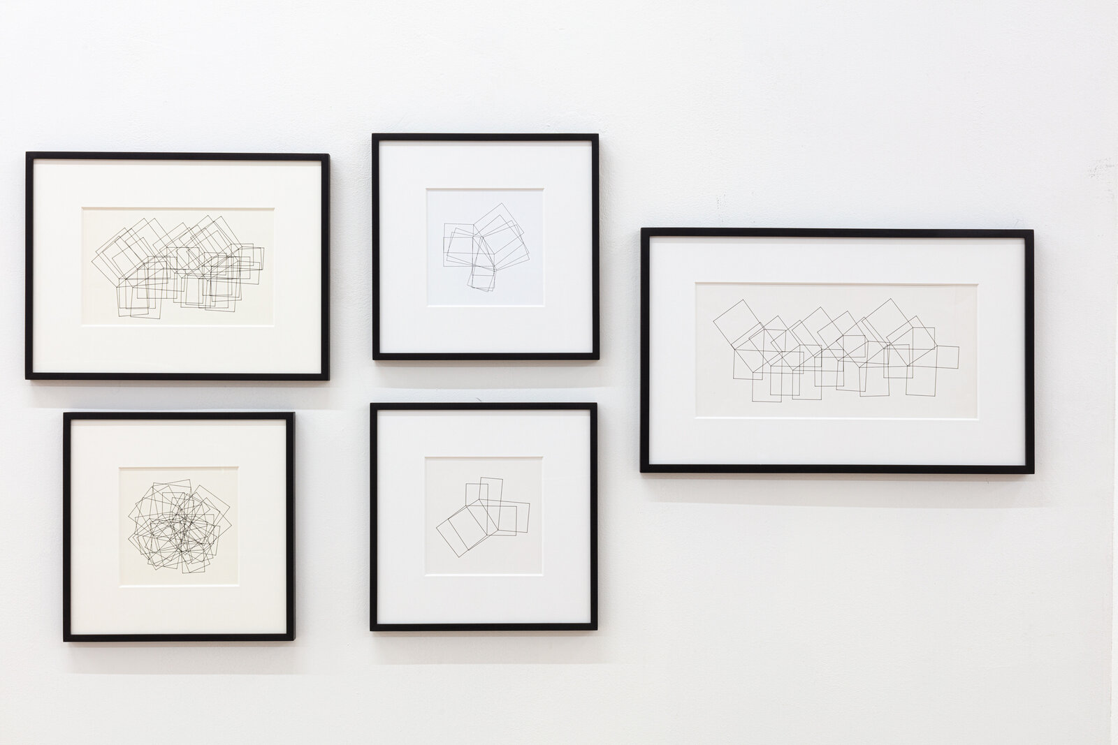 A minimalist line drawing of overlapping geometric rectangles on a plain background.