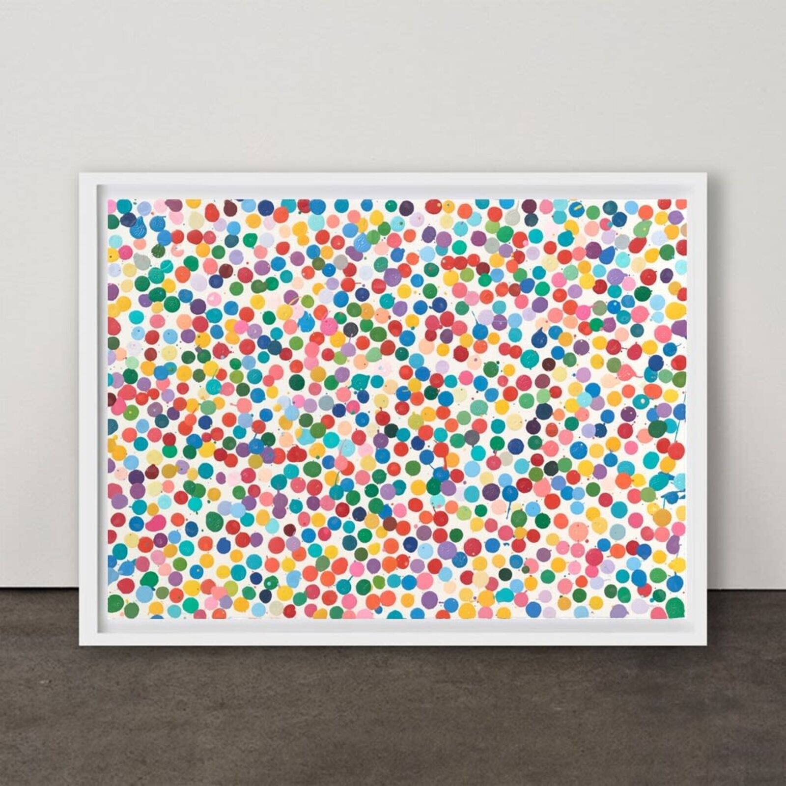 A picture of a colorful polka dot pattern on a white wall.
