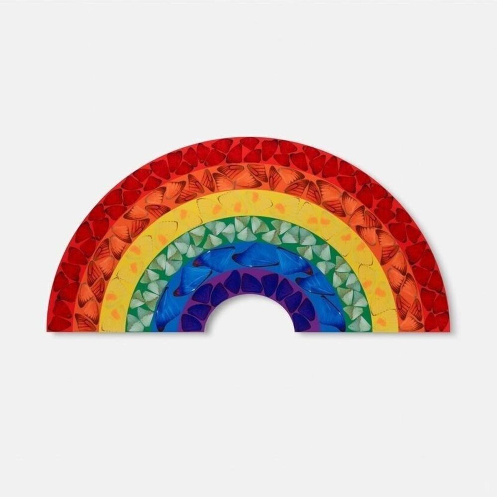 A rainbow made out of stained glass on a white background.