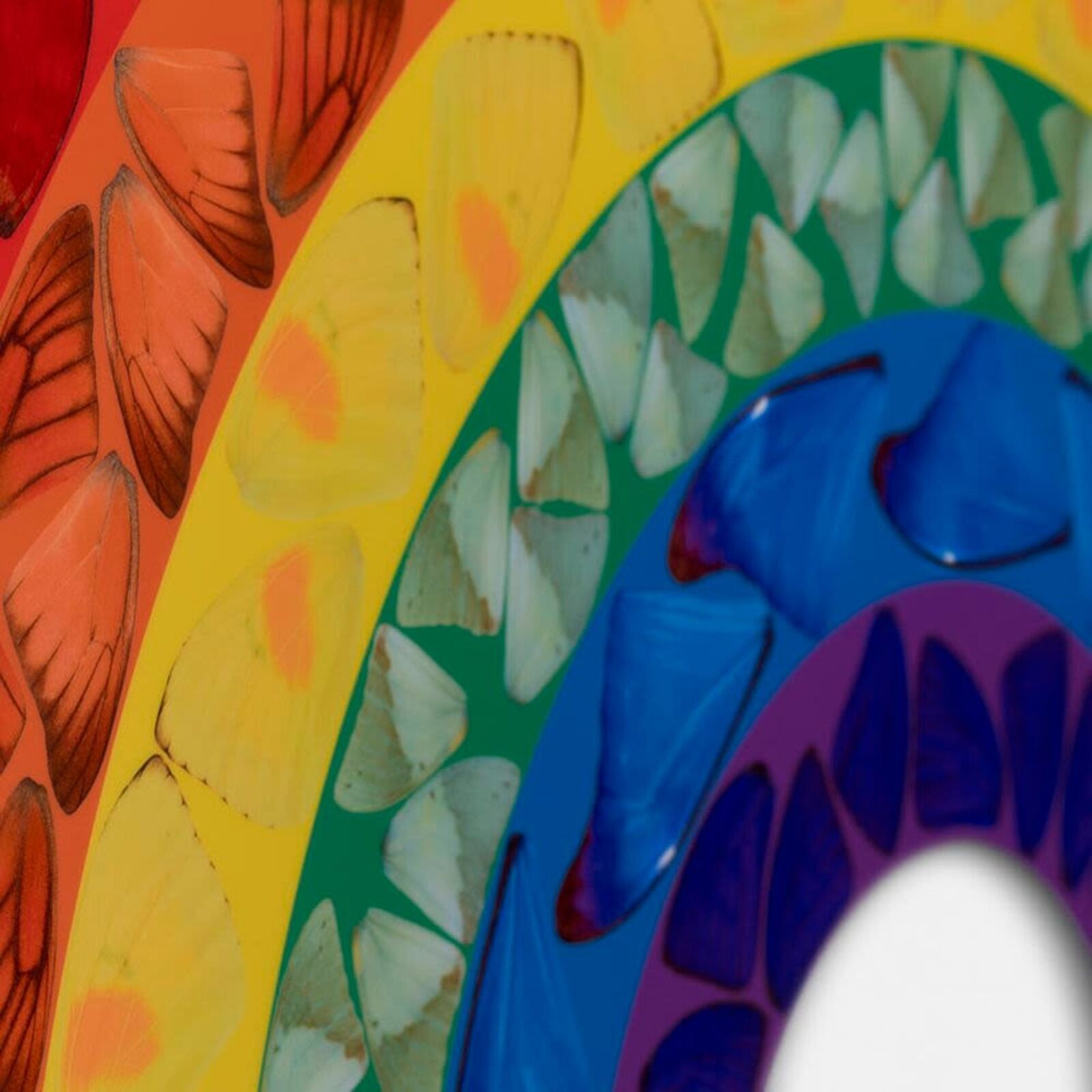 A rainbow made out of stained glass on a white background.