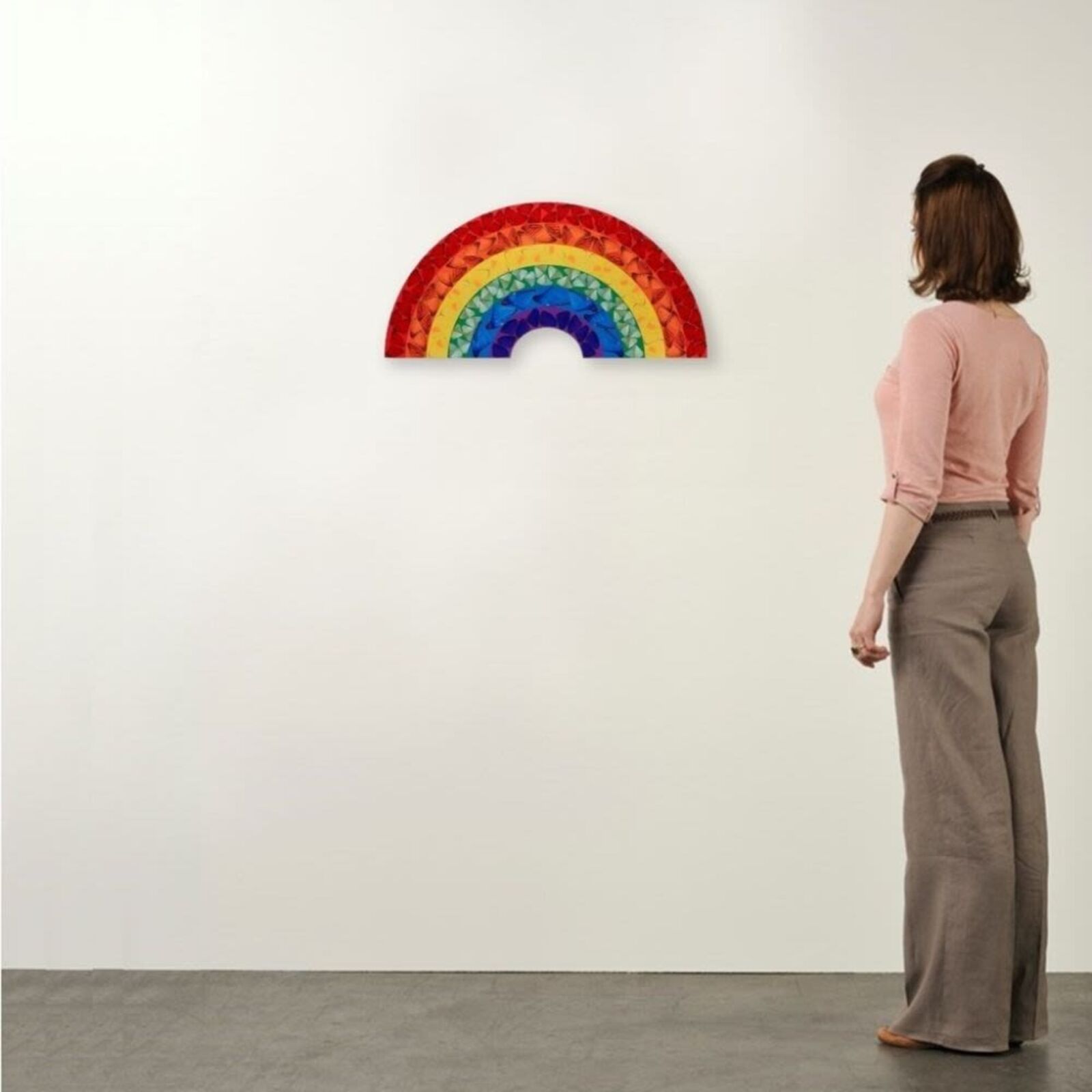 A rainbow made out of stained glass on a white background.