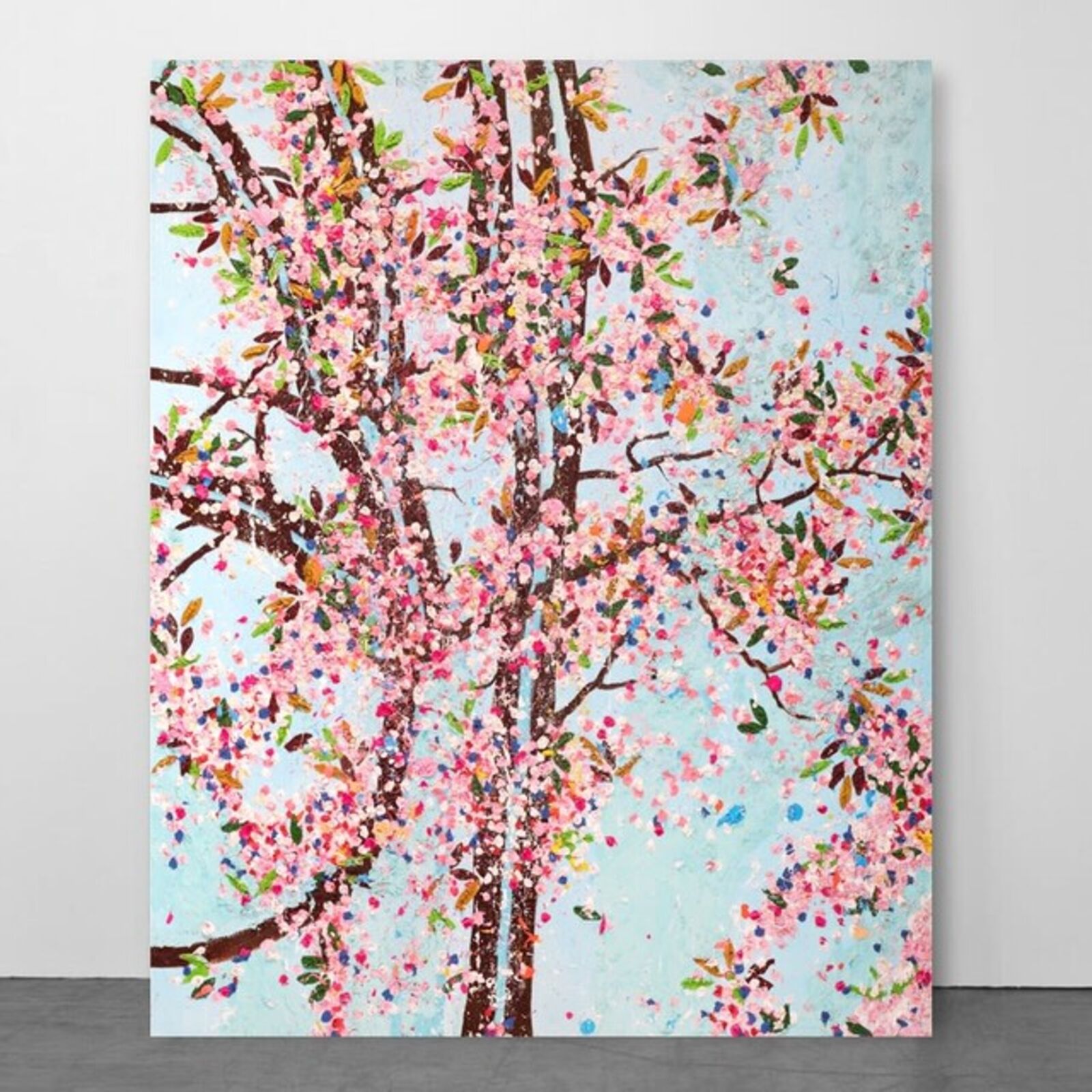 A painting of a tree with pink flowers on a blue background.