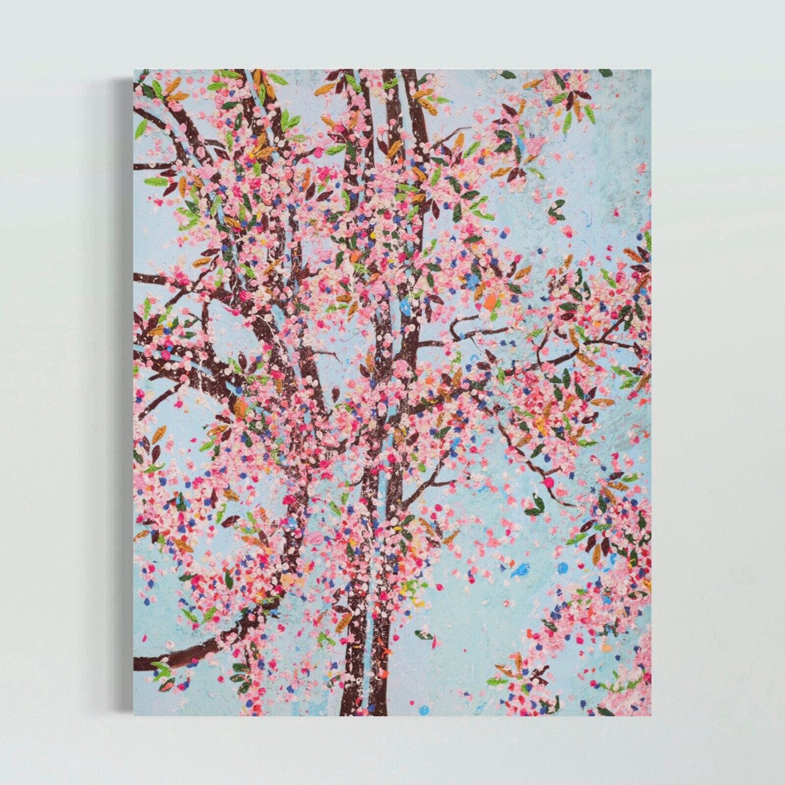A painting of a tree with pink flowers on a blue background.
