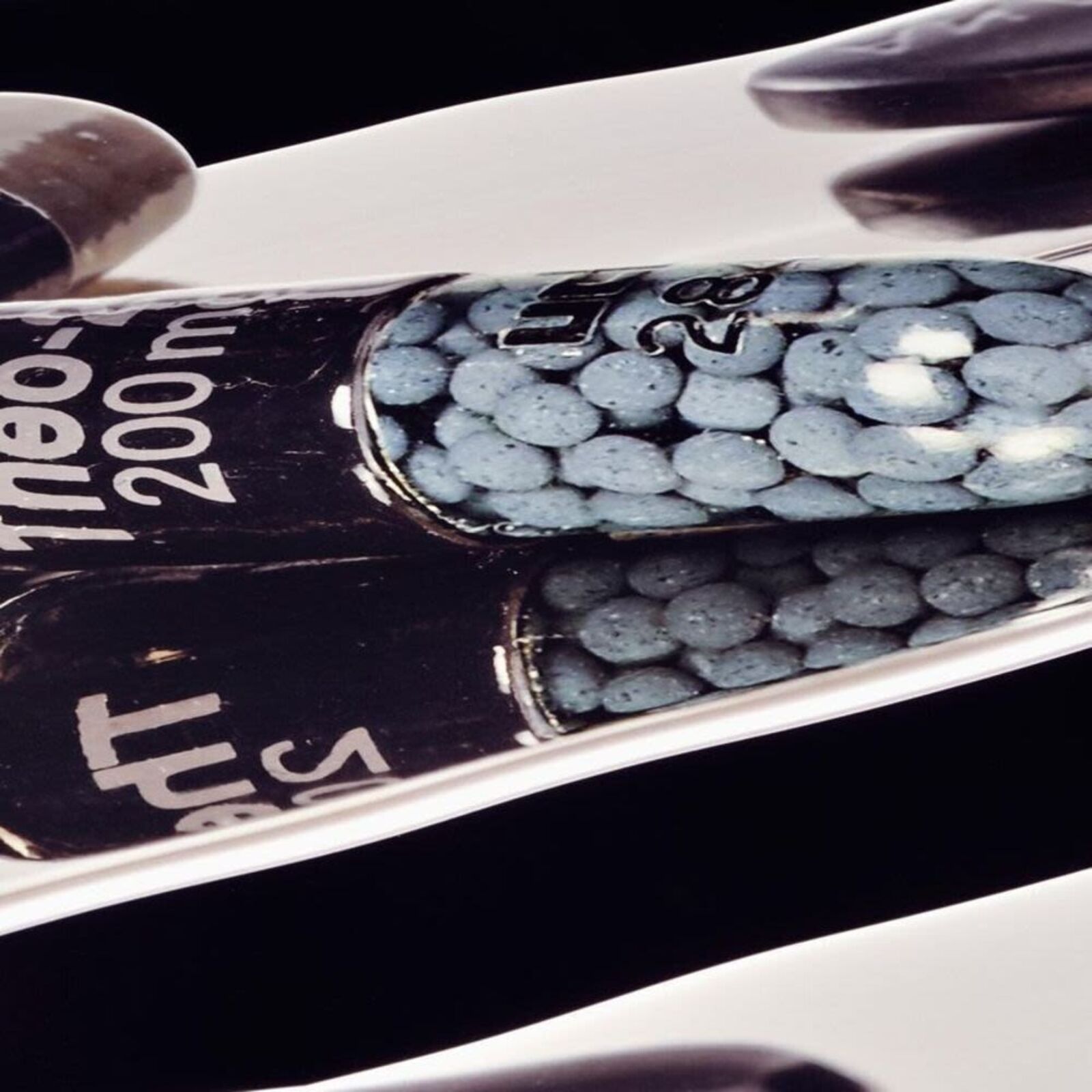 A black and white photo of pills on a shelf.
