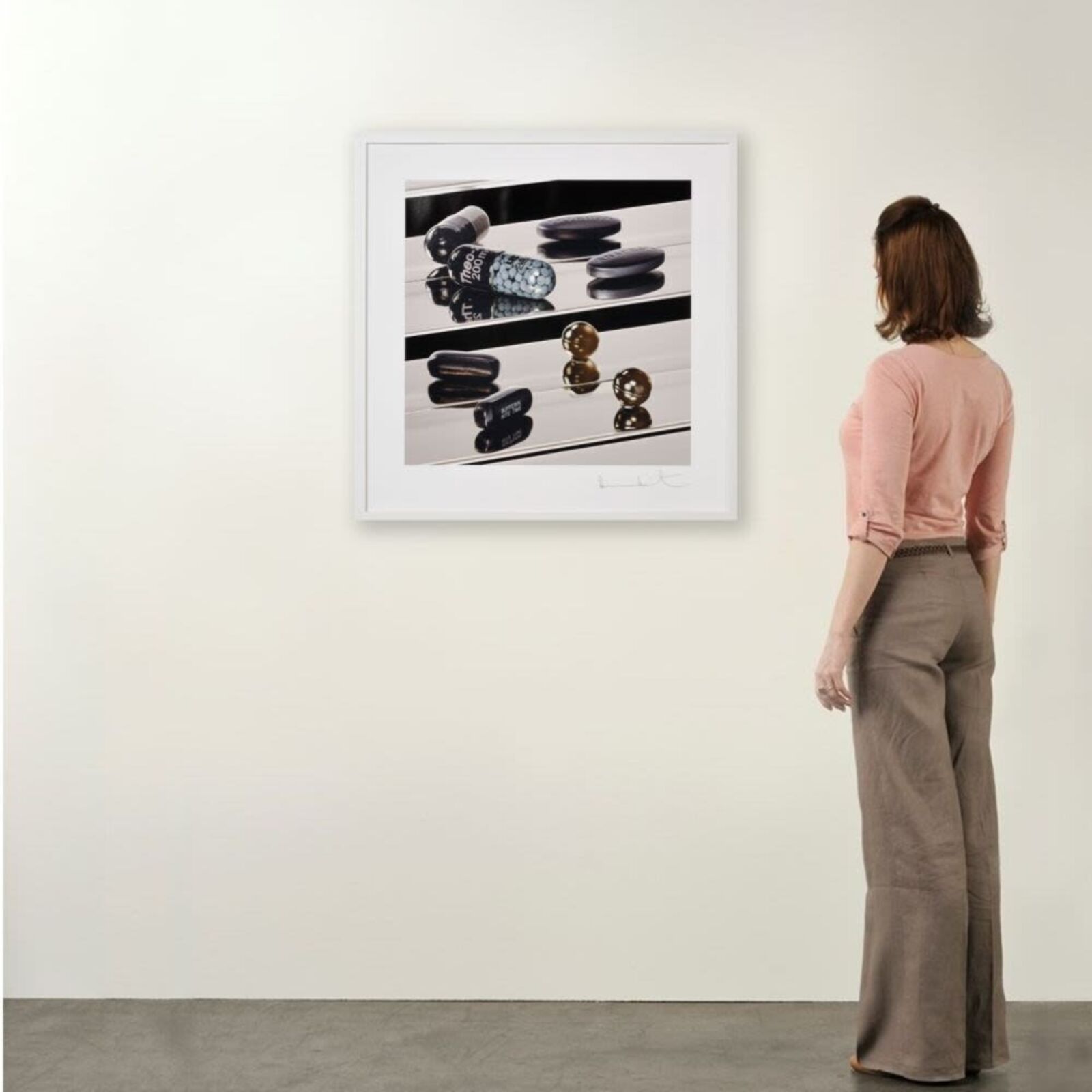 A black and white photo of pills on a shelf.